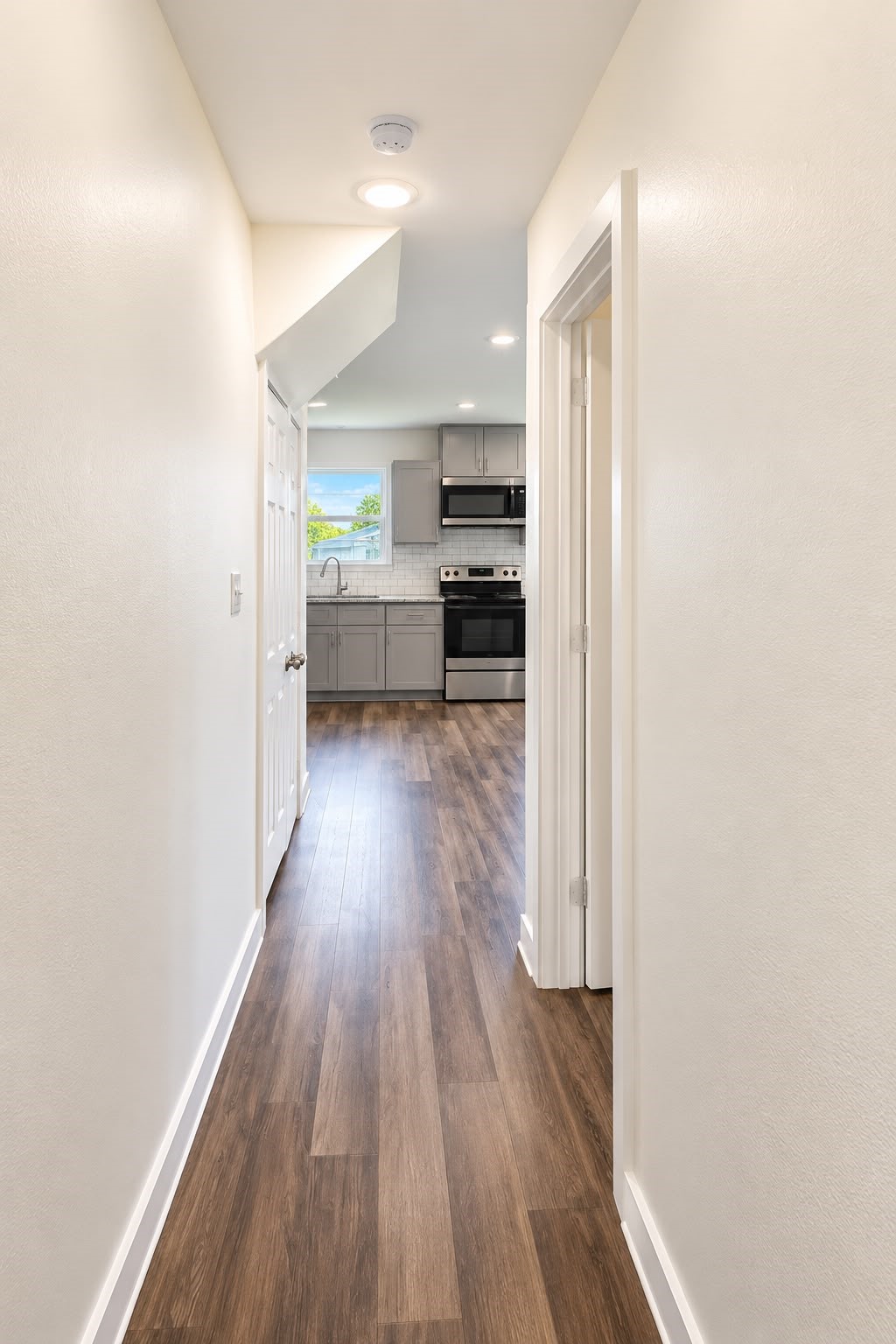 Hallway with wood style flooring throughout, no carpet to maintain.