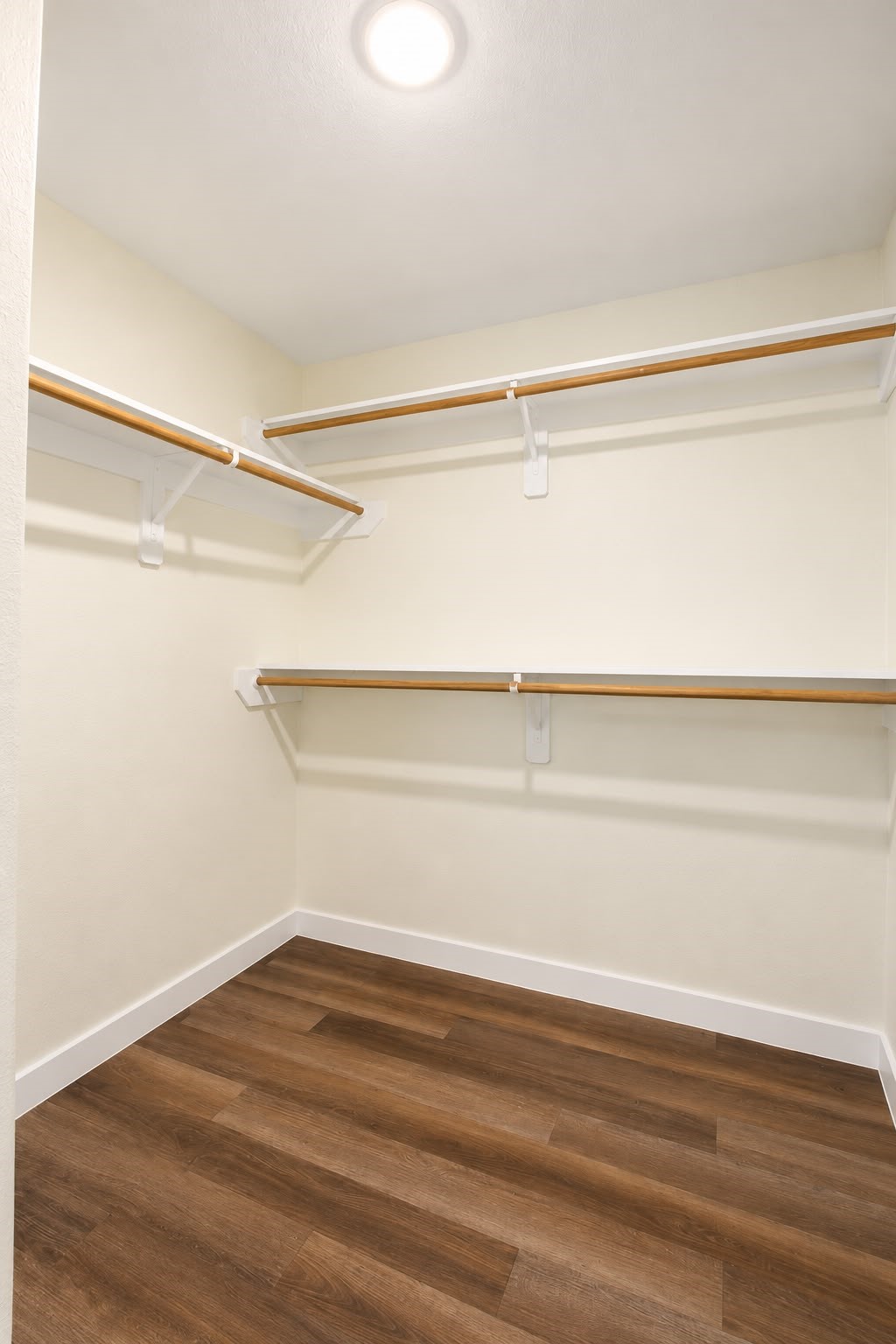Walk in closet with built in shelving for extra storage.