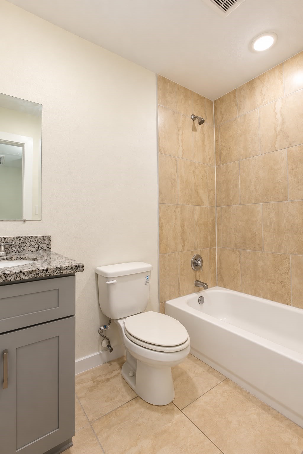 Second full bathroom with tub and shower combo and vanity.