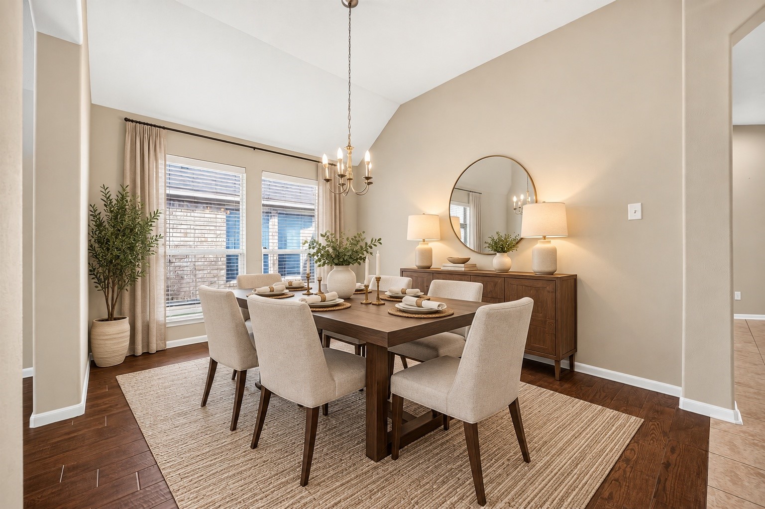 Virtually staged formal dining room highlighting the vaulted ceiling, natural light, and spacious layout.