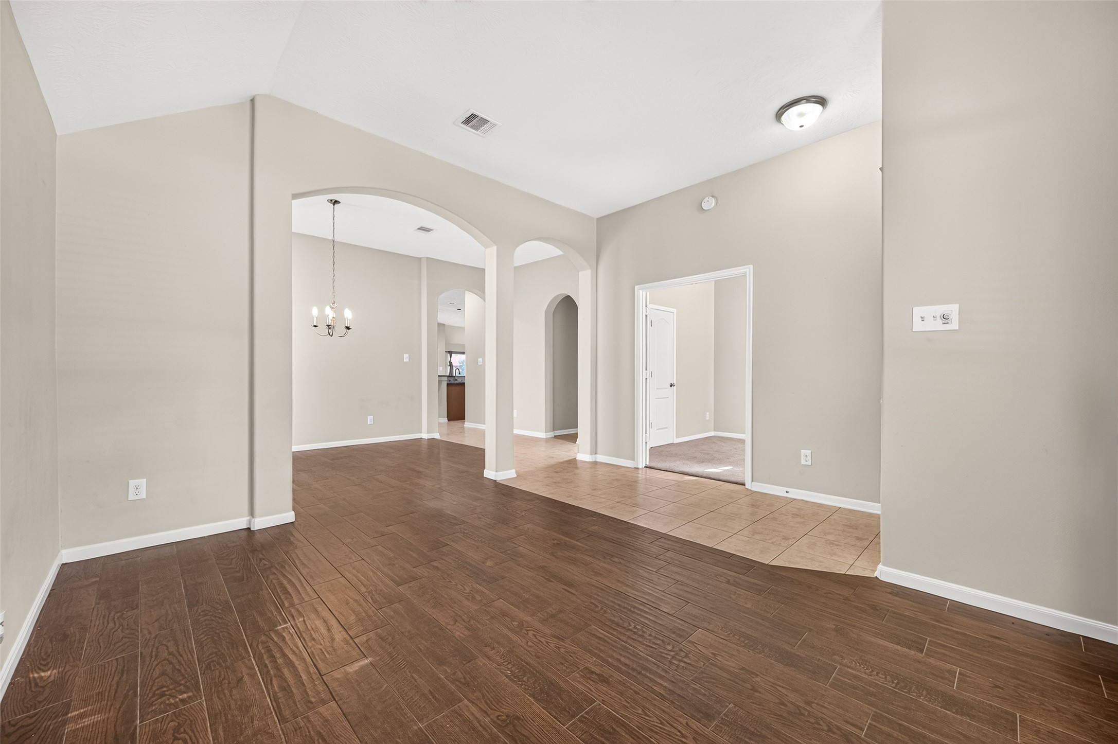 Another view of the flex area showcasing its open layout, natural light, and connection to the entryway.