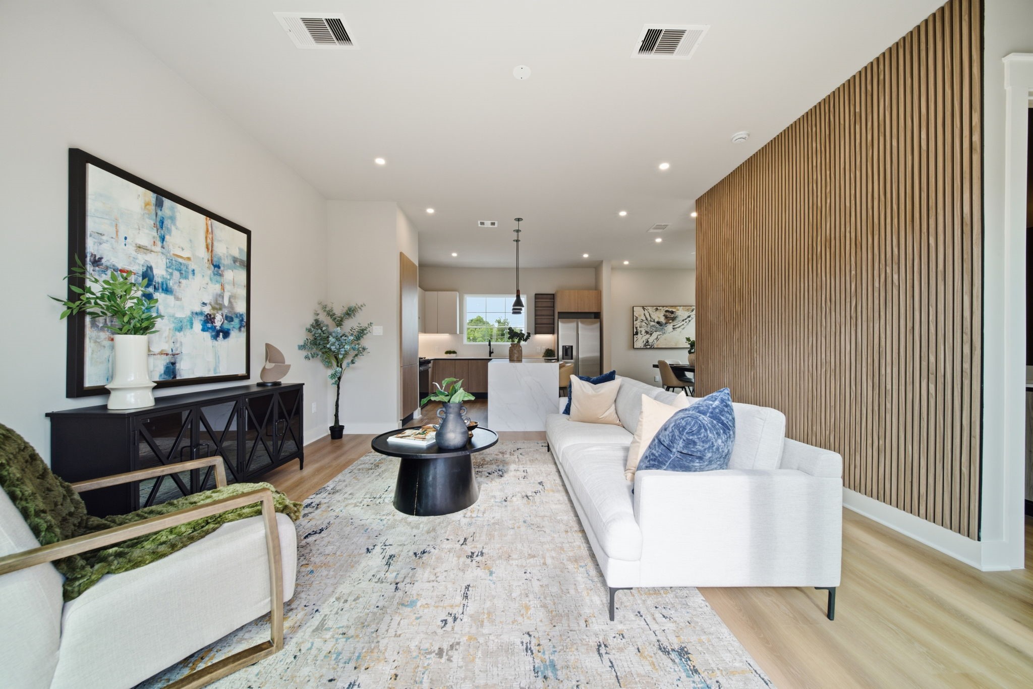 Modern finishes and recessed lighting create a sleek, polished look throughout the living area.