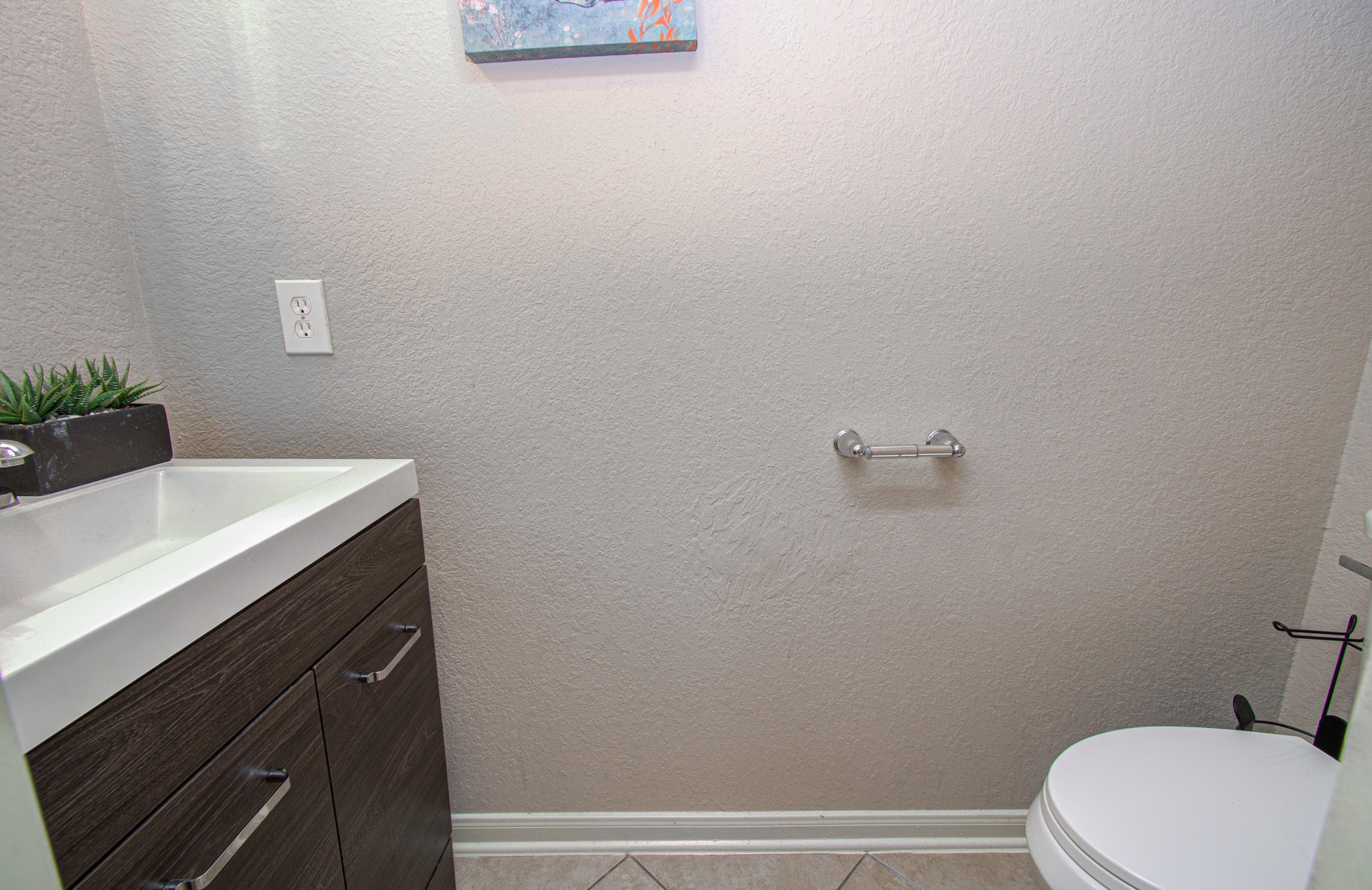Conveniently located on the first floor, the half bathroom offers added functionality for everyday living and entertaining. Ideally situated for guests, this convenient feature allows visitors to access a restroom without needing to go upstairs, adding practicality and comfort to the home's thoughtful layout.