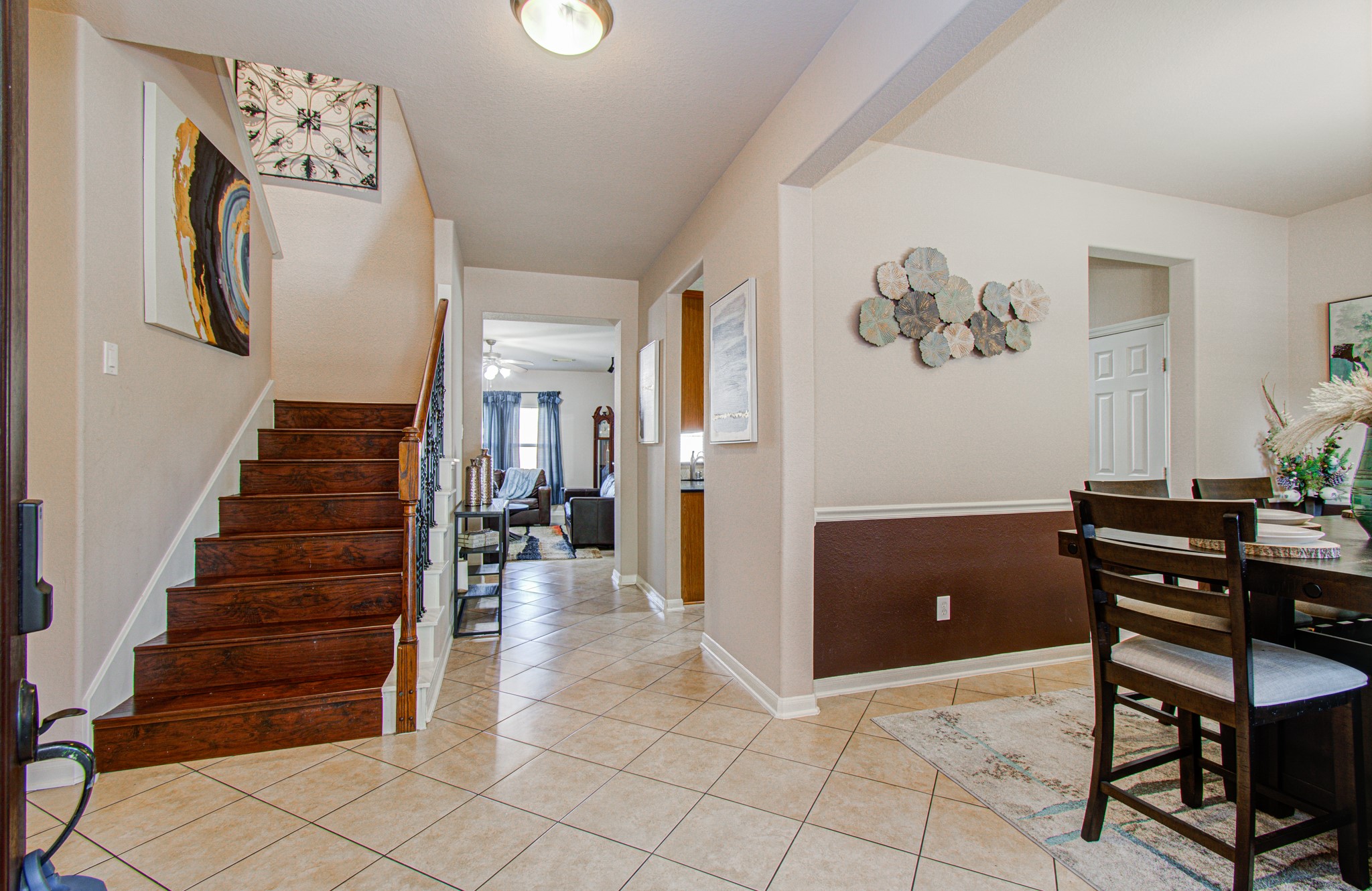 Step inside to an inviting entryway that opens to a welcoming view of the staircase, formal dining room, and main living area. This thoughtfully arranged entrance creates an appealing first impression while offering a natural flow into the home's gathering spaces. Whether welcoming guests for a special occasion or enjoying everyday moments, this entryway sets the stage for comfortable living and memorable gatherings.