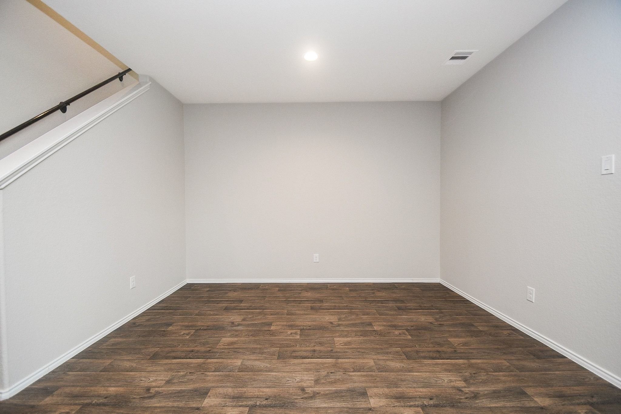 Bright and spacious dining room with elegant wood flooring, perfect for a cozy retreat or home office setup.