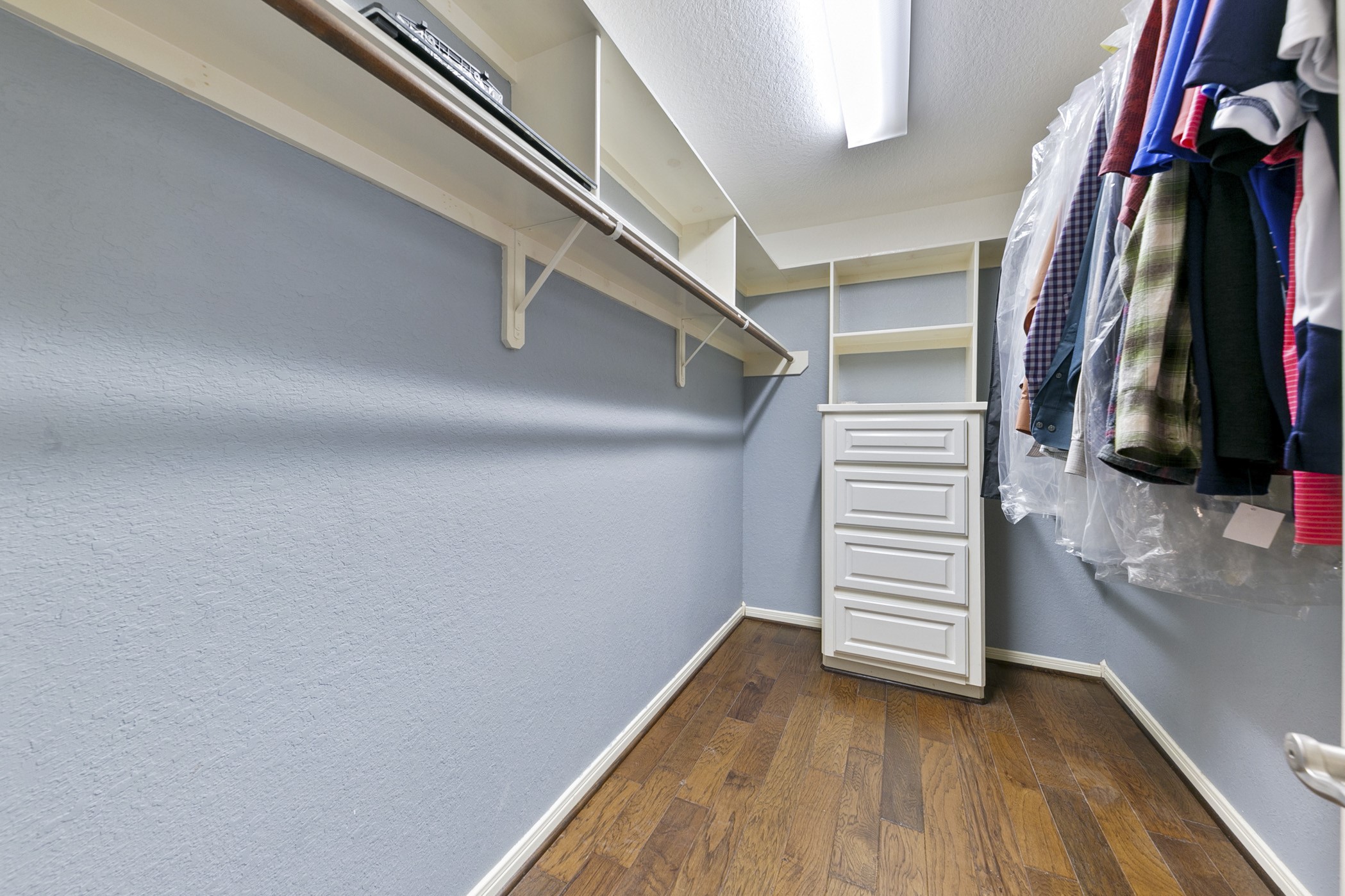 Primary bedroom walk in closet
