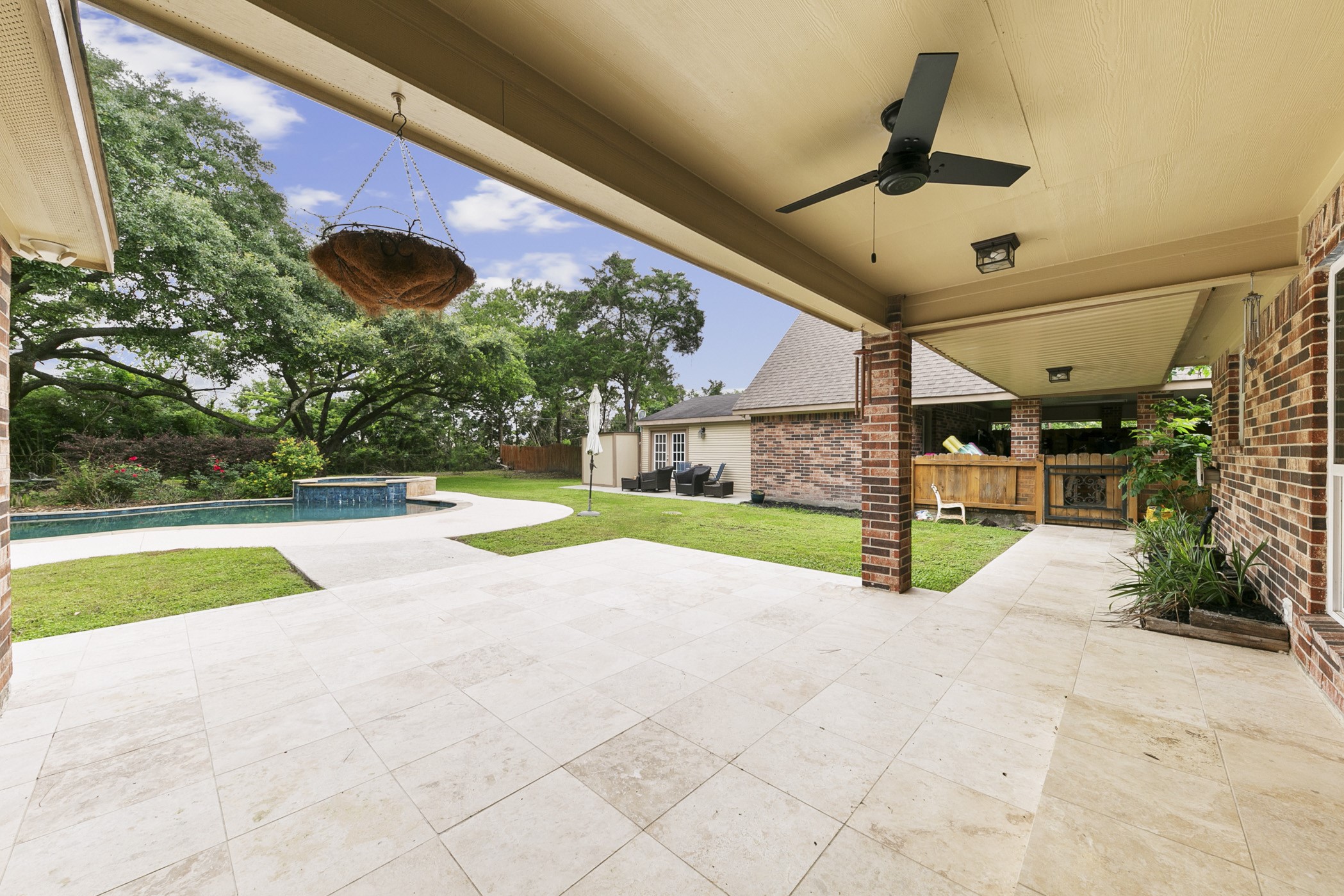 Oversized tile and covered porch overlooking pool area