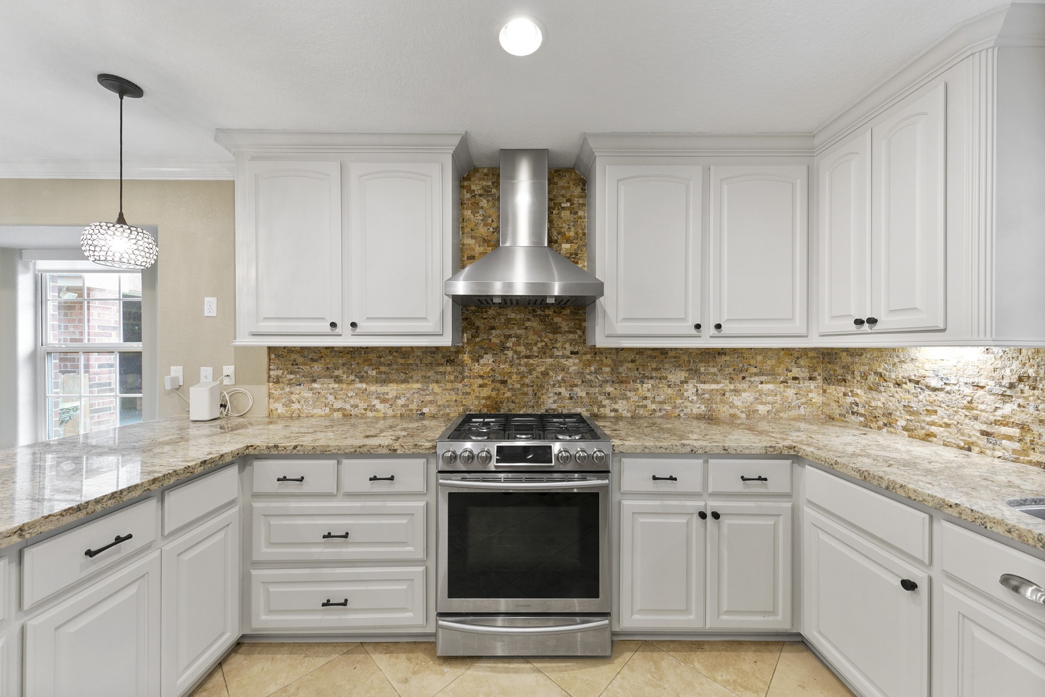 Vent hood with ceiling height stone backsplash