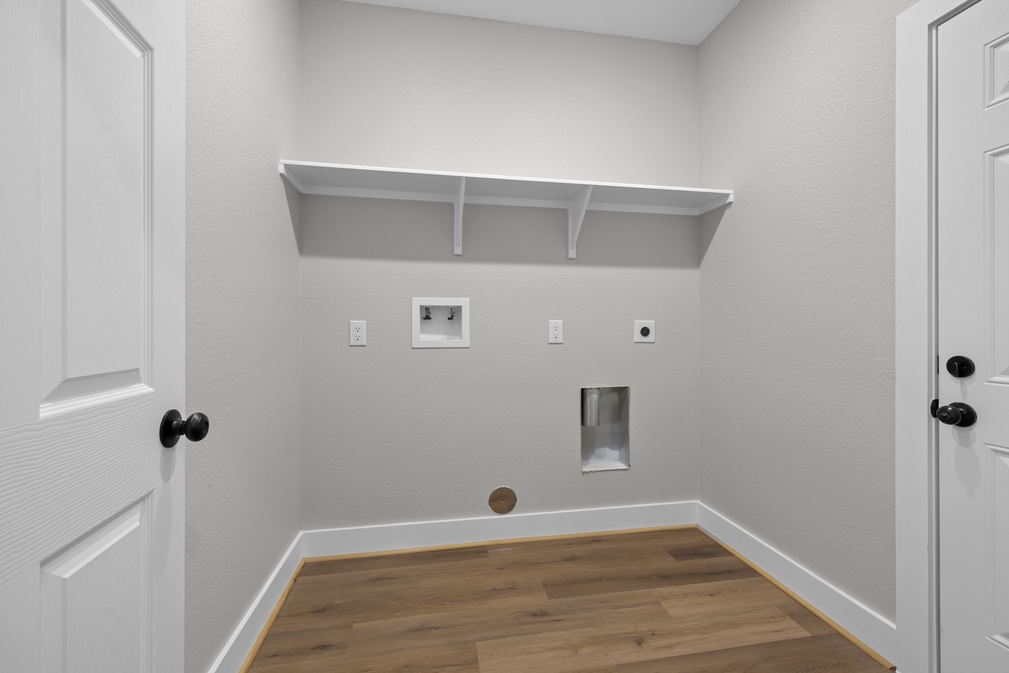 Laundry room off garage and entry hall