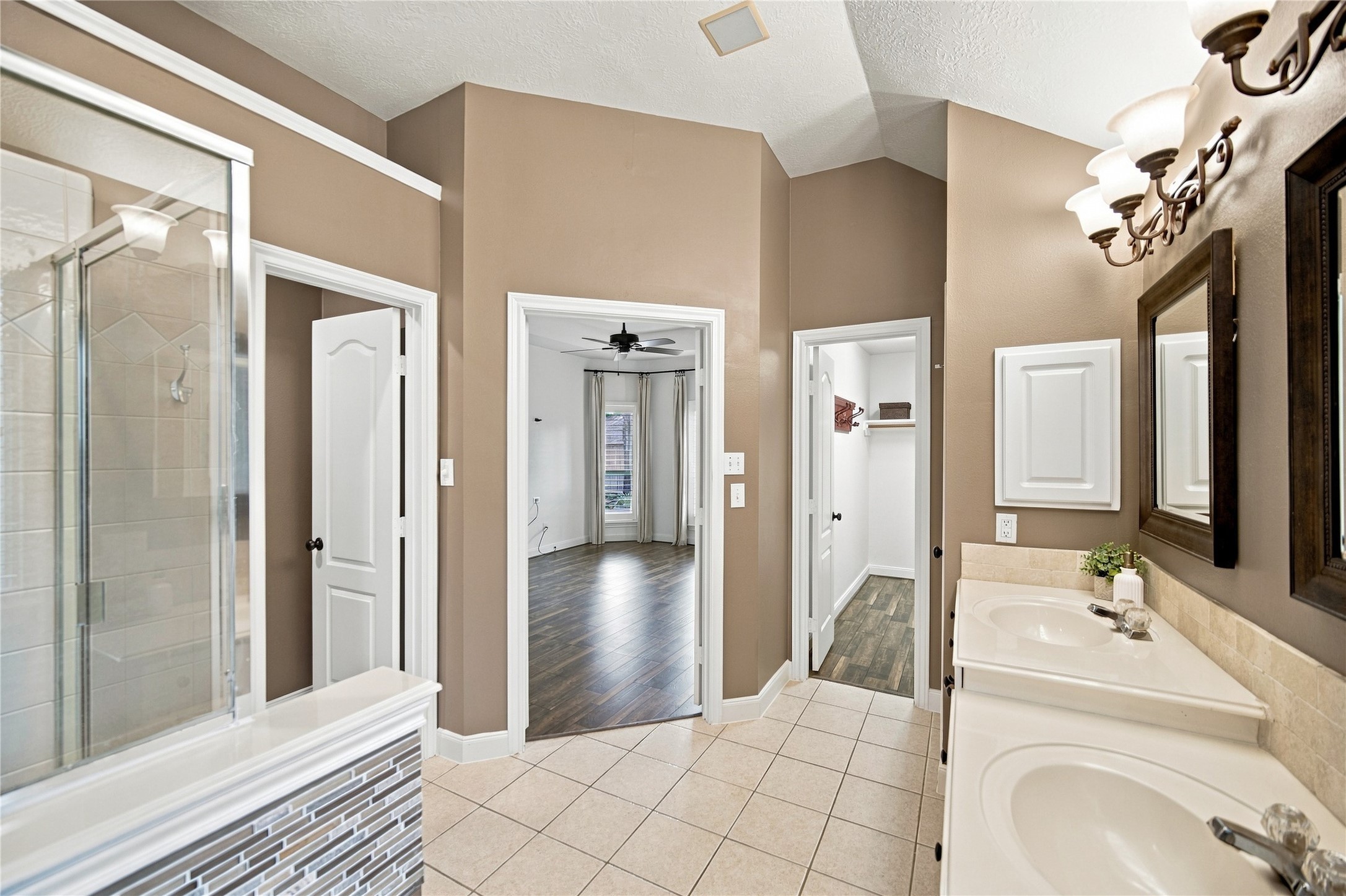 To the right of the double-door entry is the second of the primary suite's TWO walk-in closets, along with a convenient linen closet for additional storage.