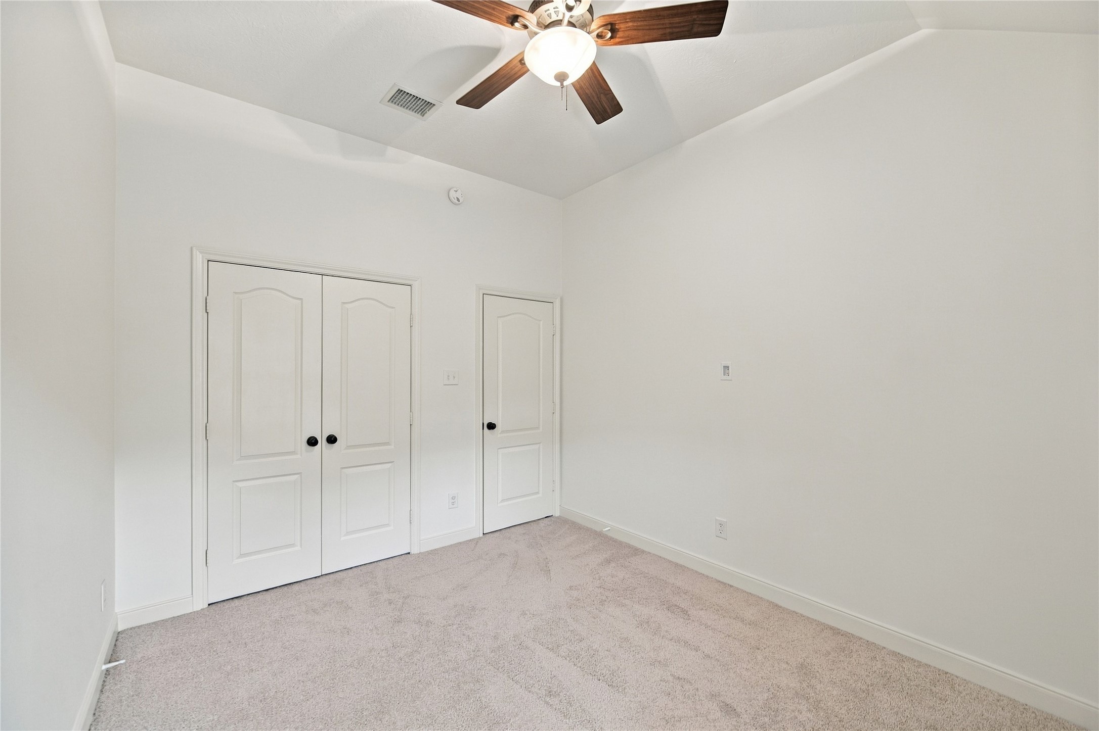 The additional view of this bedroom shows the double door closet at left. Both secondary bedrooms have a ceiling fan and have been freshly painted.