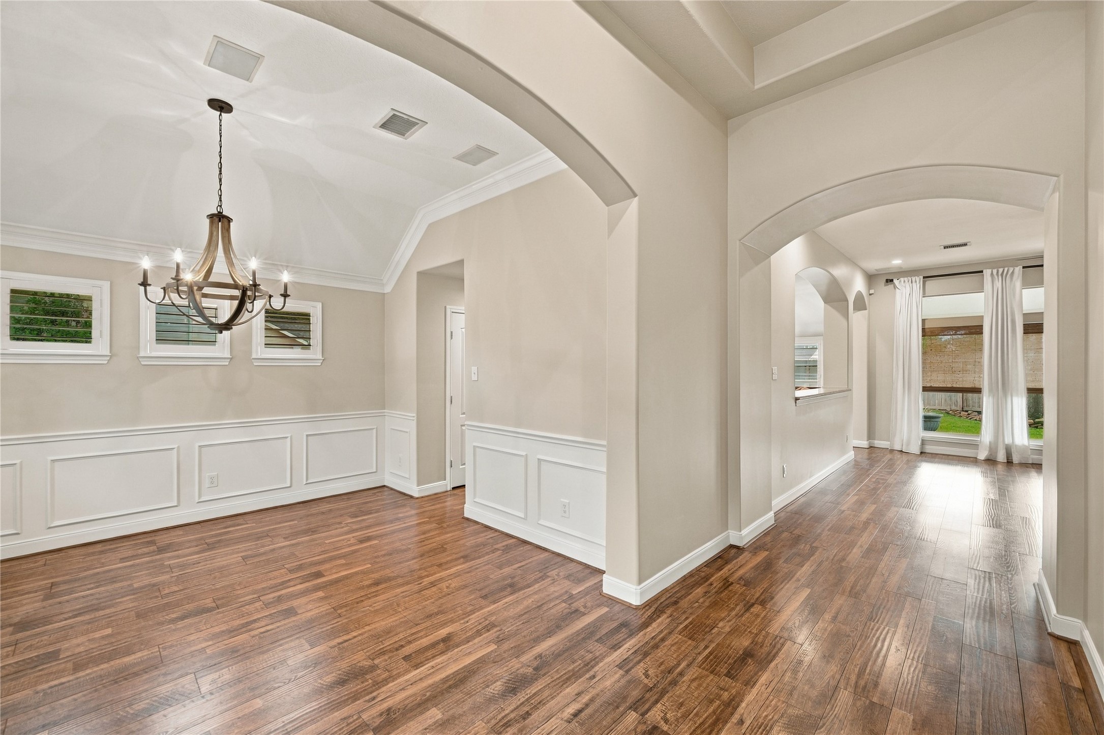Enter the home and you will be met by gleaming wood-look floors throughout the main living areas, high ceilings, arched doorways, plus picture-frame molding in the formal dining room at left. Enter the home and you will be met by gleaming wood-look floors throughout the main living areas, high ceilings, arched doorways, plus picture-frame molding in the formal dining room at left.