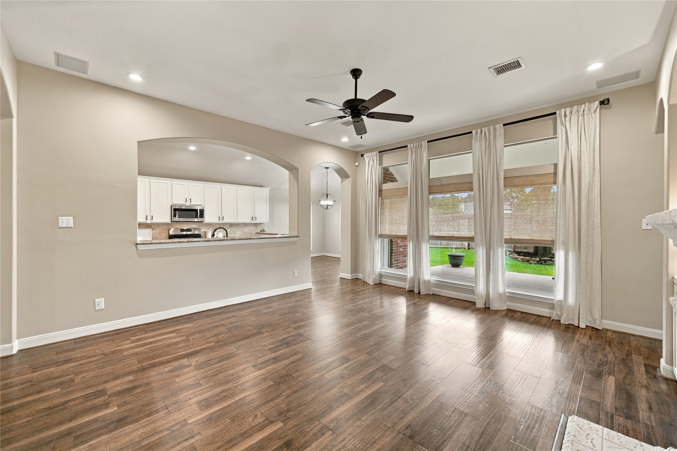The open-concept family room is conveniently situated adjacent to the kitchen, making it easy to visit with family and friends while preparing meals. The large windows provide abundant natural light and lovely views of the backyard! The open-concept family room is conveniently situated adjacent to the kitchen, making it easy to visit with family and friends while preparing meals. The large windows provide abundant natural light and lovely views of the backyard!