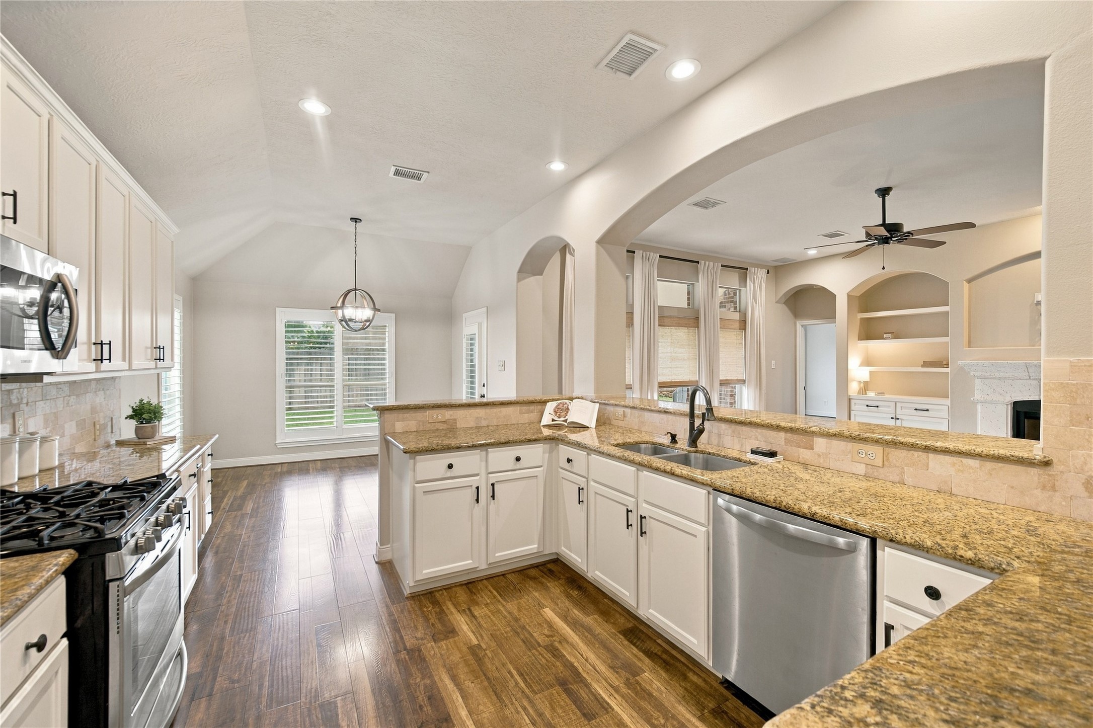 With generous counterspace galore and an abundance of cabinets, this inviting kitchen offers plenty of room for meal preparation and storage.