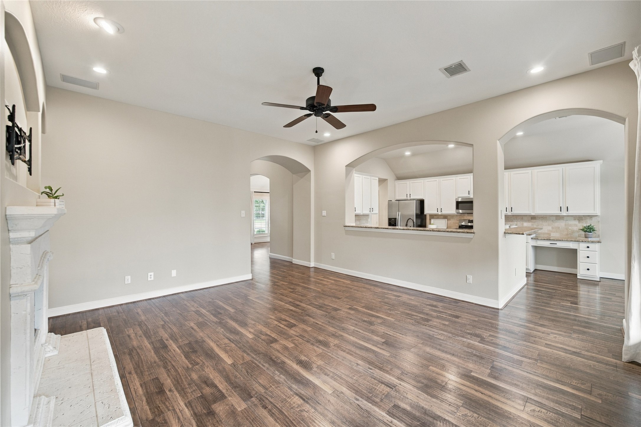 A sweeping view of the family room showcases the home's comfortable layout. Freshly painted throughout and featuring neutral finishes, this inviting home is move-in ready!
