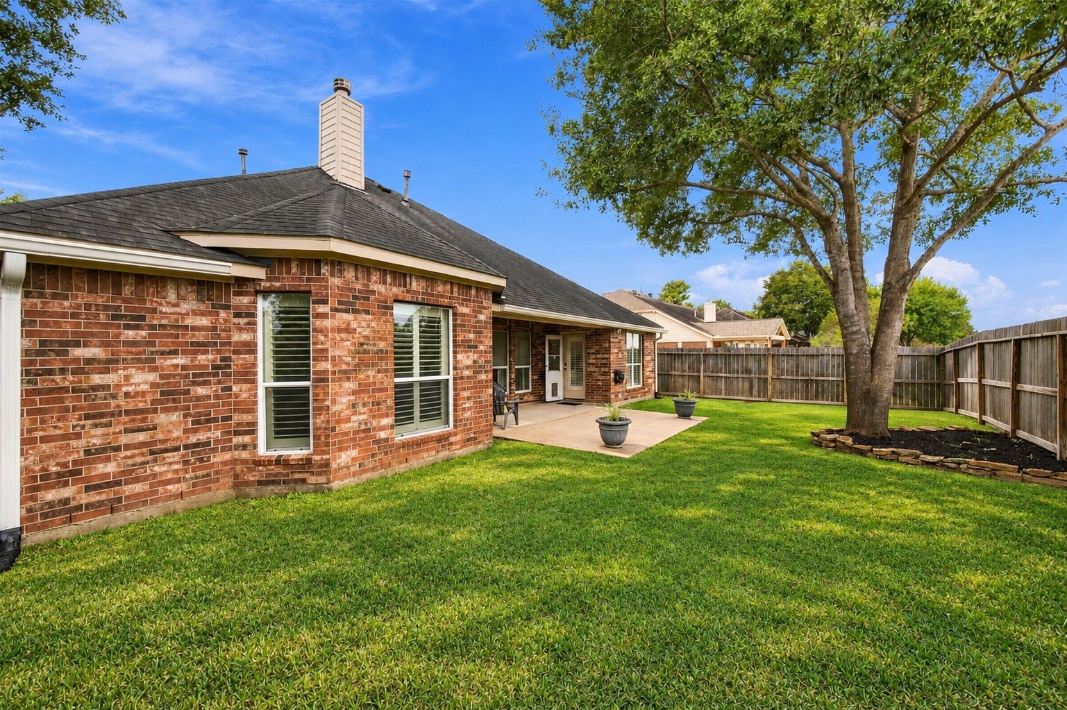 Another view of the home's backyard, showing plenty of space to enjoy the outdoors.