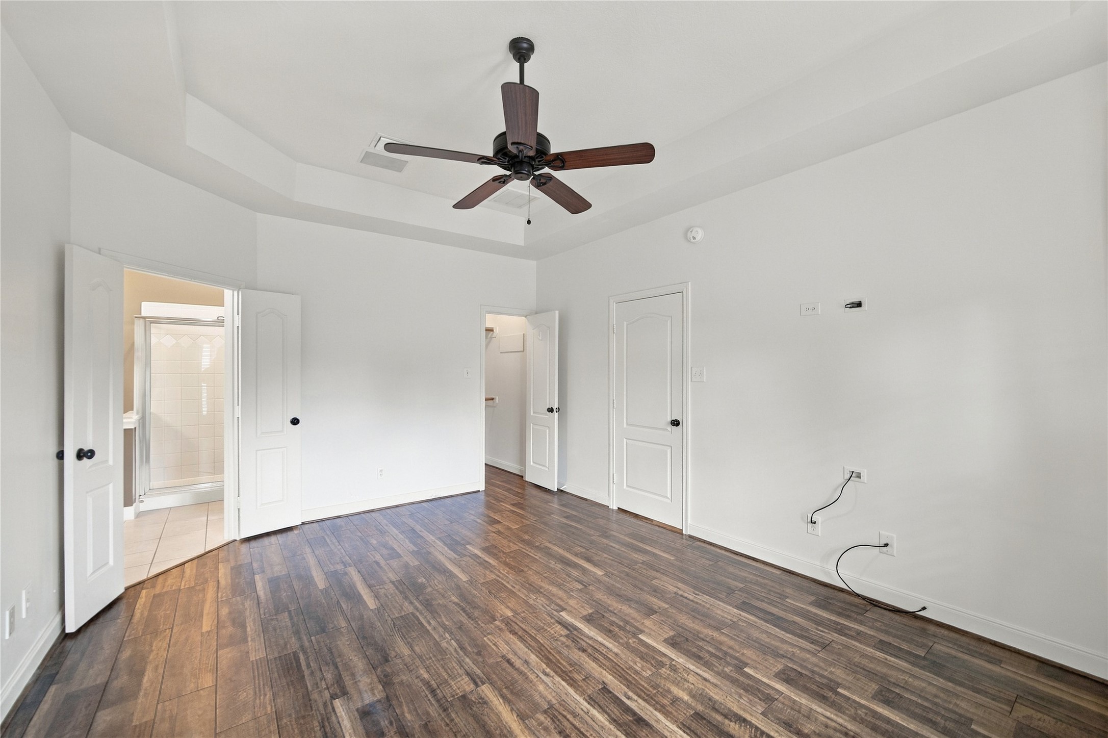 At left the primary suite's connecting bathroom and at right is the first of two walk-in closets.