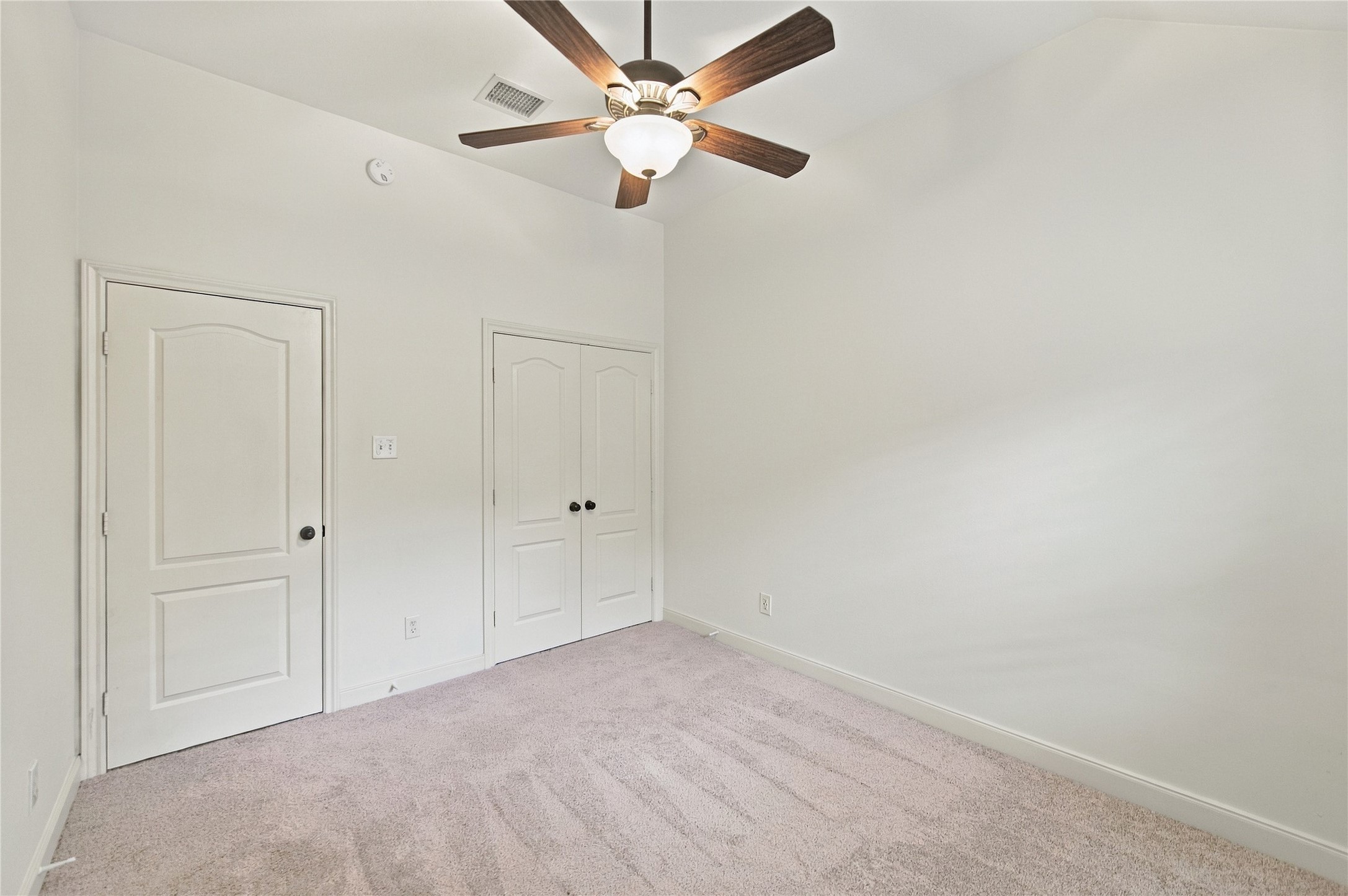 From this angle of the second bedroom, you will see the double door closet at right.