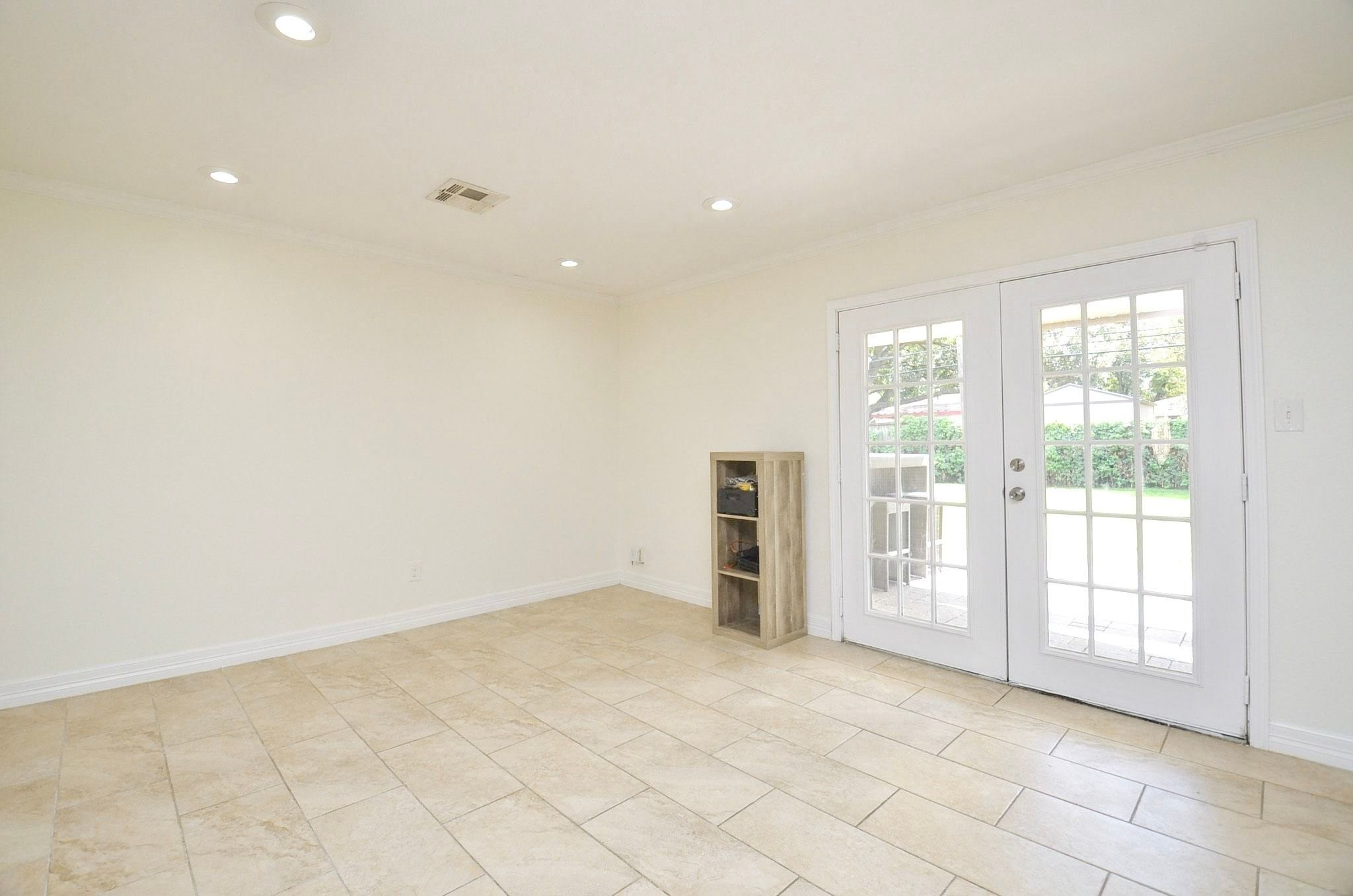 Kitchen/dining combination with french doors that open to backyard oasis.
