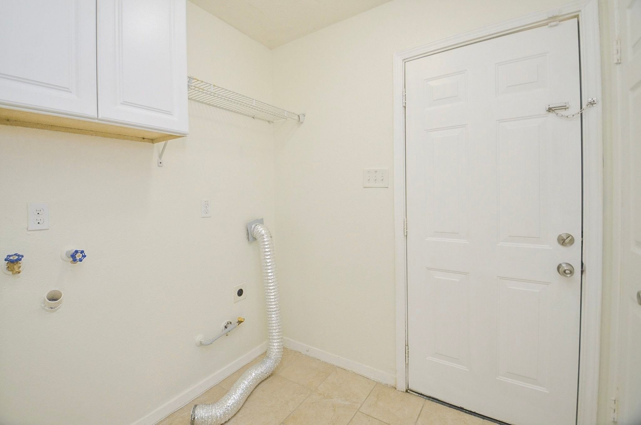 Laundry area is located adjacent the kitchen.