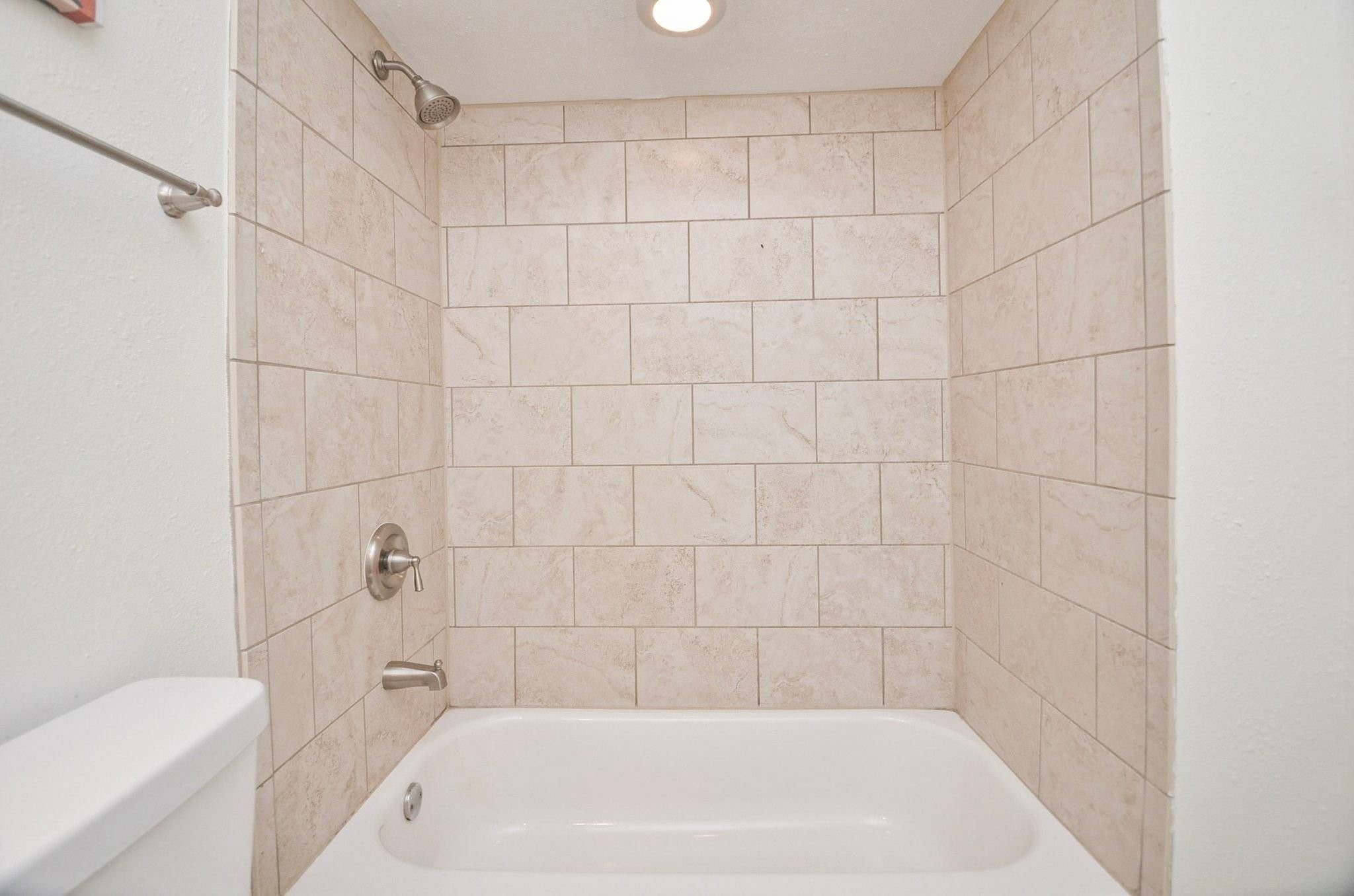 Tiled tub/shower combination.