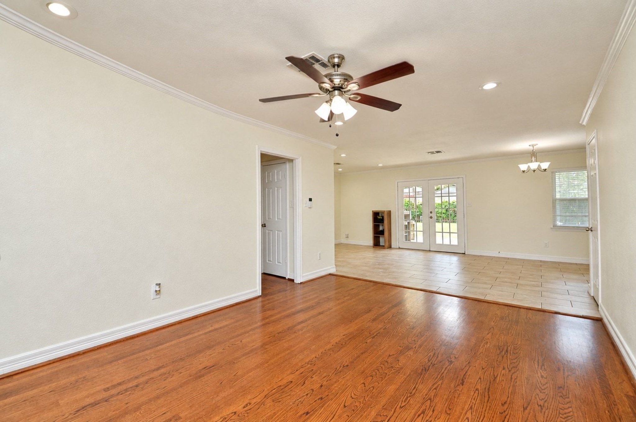 Fresh paint and recessed lighting highlight the neutral tile and wood floors!