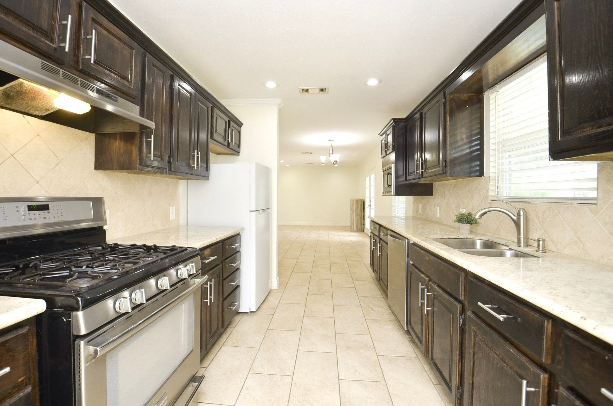 Bring out your inner chef in this well-equipped kitchen with ample counter space, rich wood cabinetry, and stainless steel appliances.