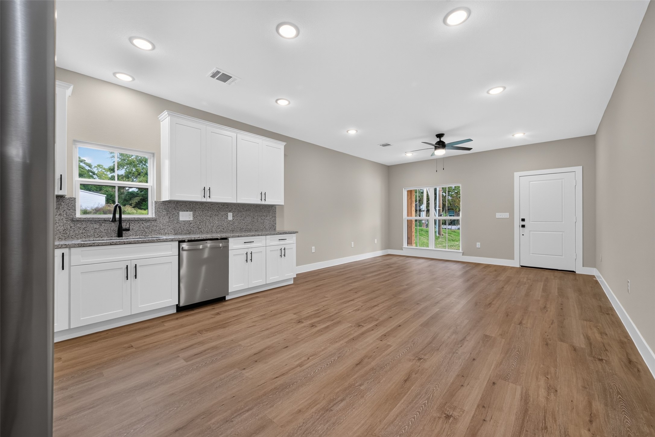 Open concept living, dining, and kitchen space. Open concept living, dining, and kitchen space.