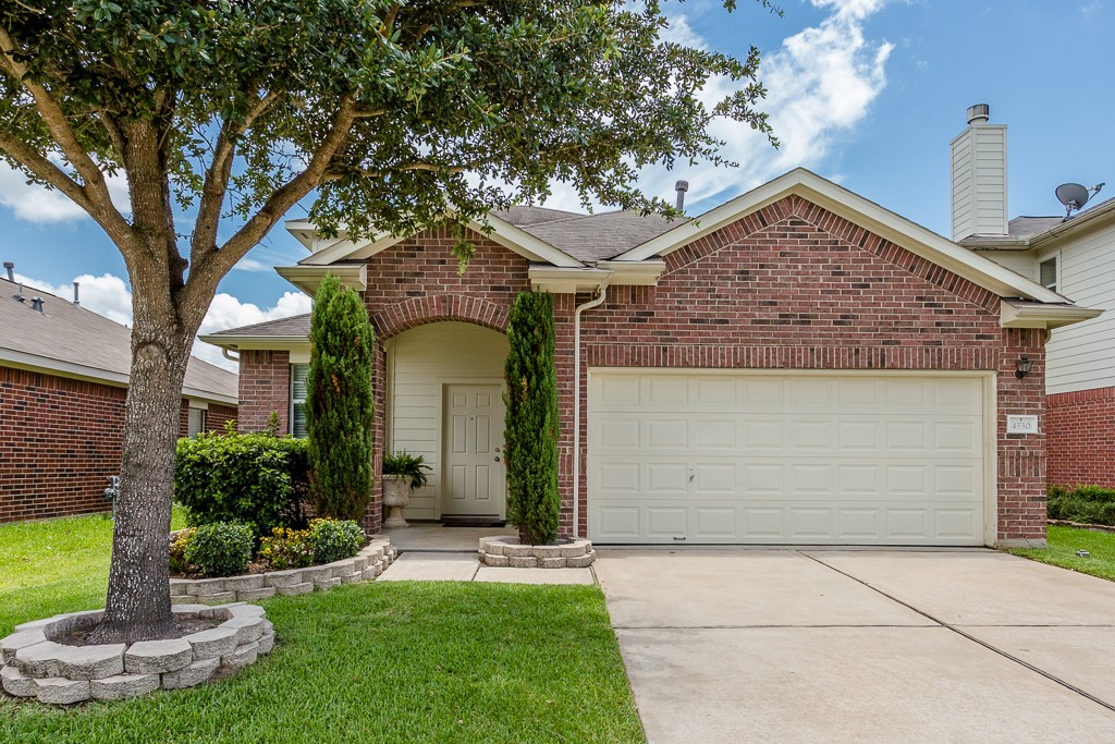 Charming brick home with a welcoming arched entryway, neatly landscaped front yard, and a spacious two-car garage. Charming brick home with a welcoming arched entryway, neatly landscaped front yard, and a spacious two-car garage.