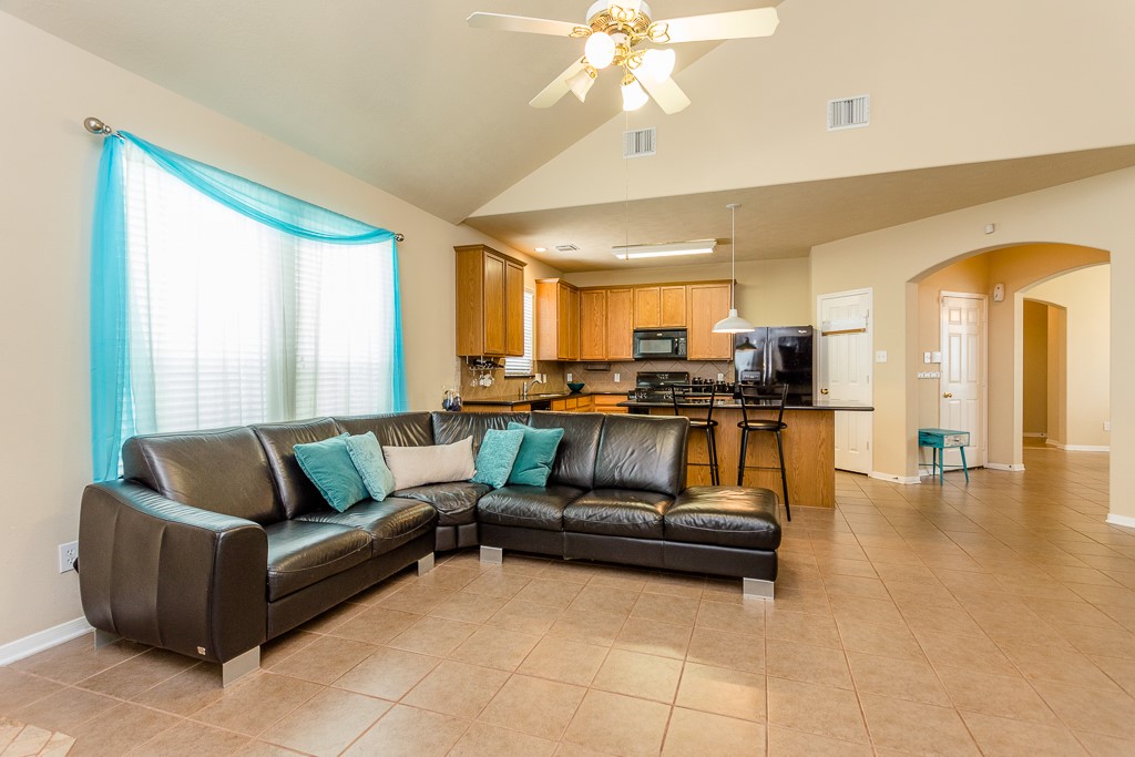 Open-concept living area with vaulted ceilings, perfect for entertaining.