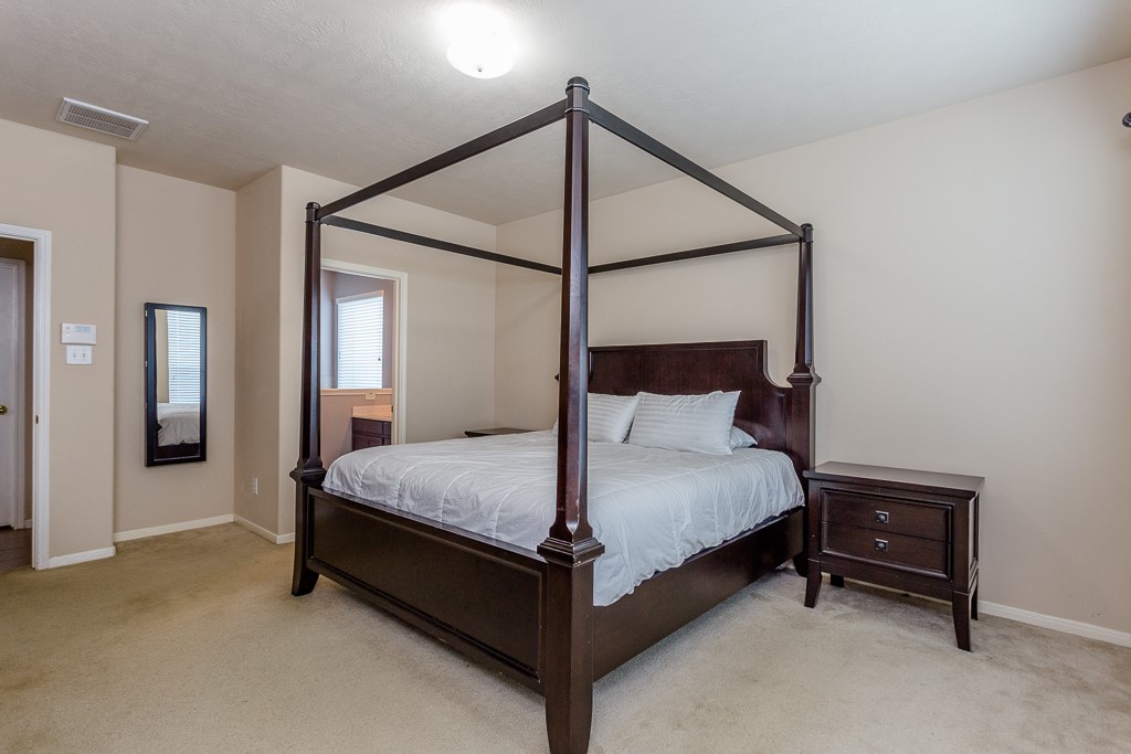 Master suite with neutral walls, and an ensuite bathroom.