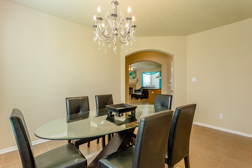Elegant dining area and an arched doorway leading to the cozy living space.