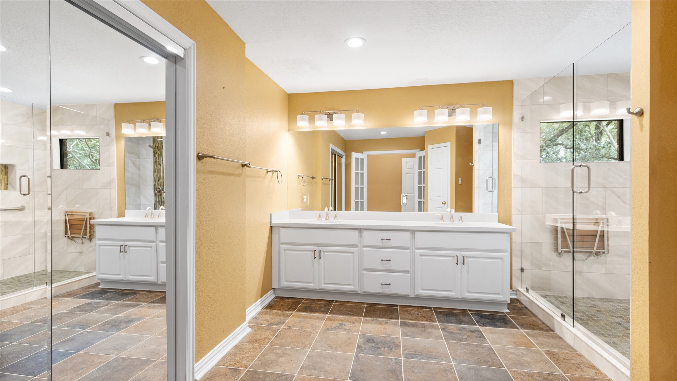 Primary bath has double vanities and walk in shower.
