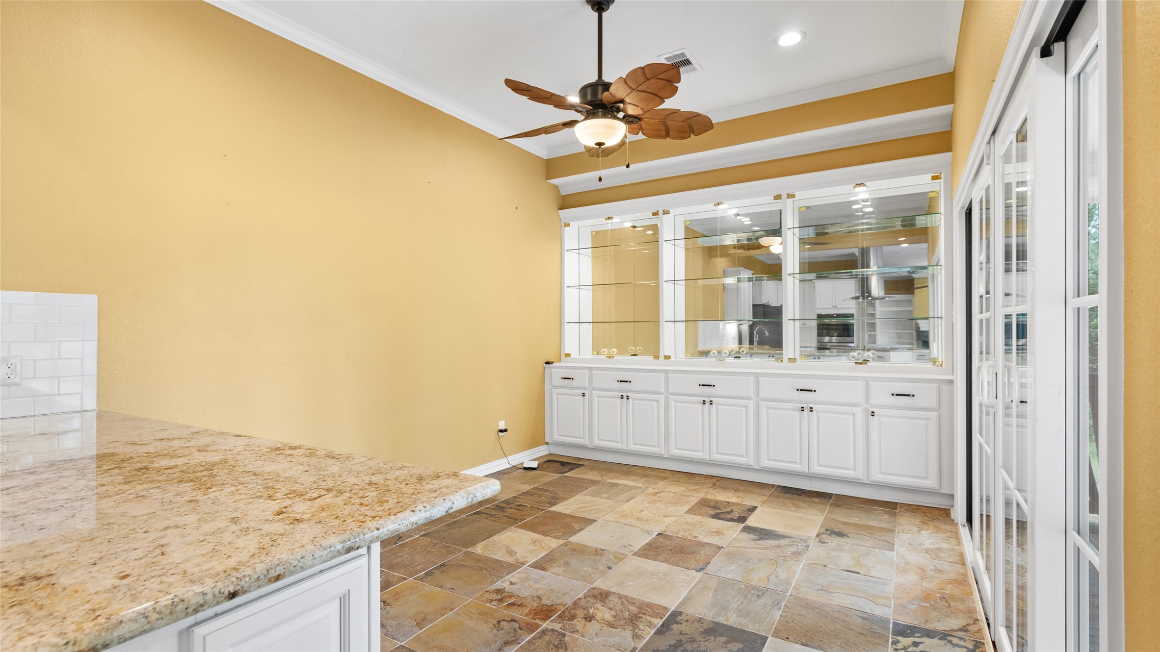 Sun room off the kitchen with beautiful custom built ins!