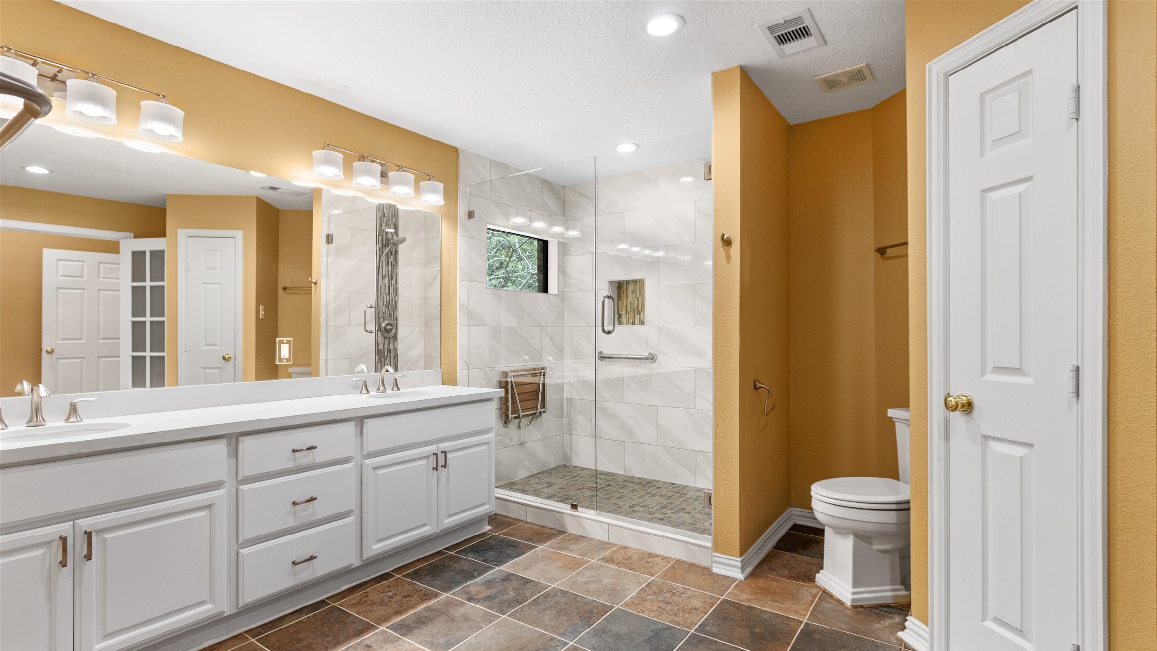 Primary bath has double vanities and walk in shower.