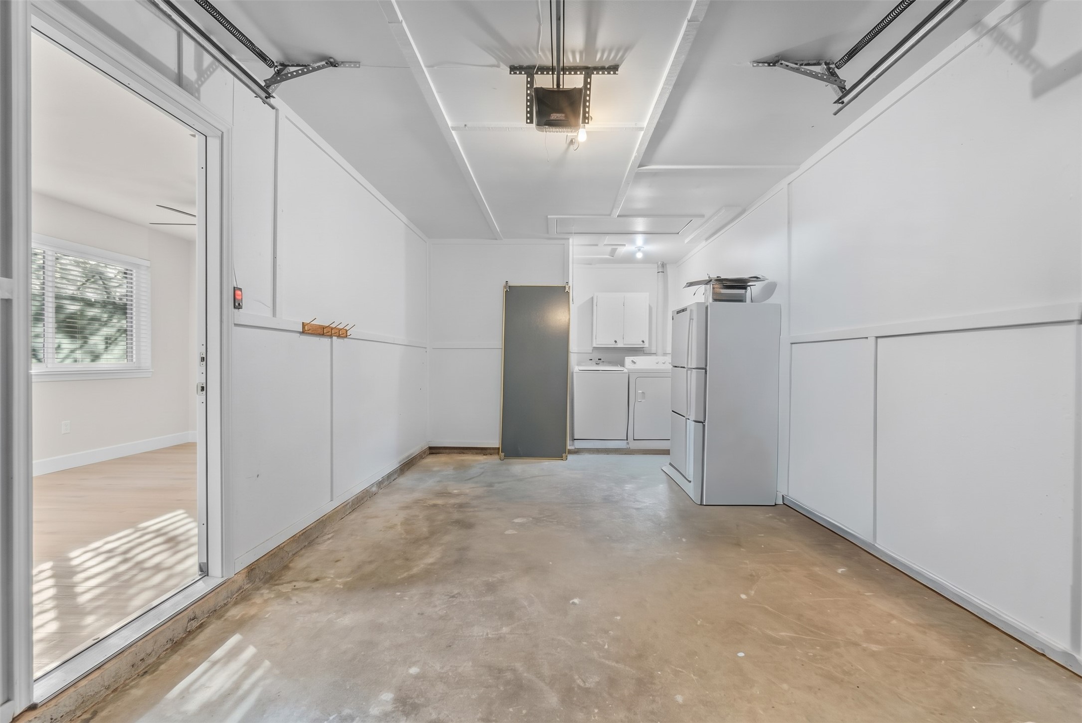 Attached one-car garage featuring an automatic garage door opener and direct interior access.