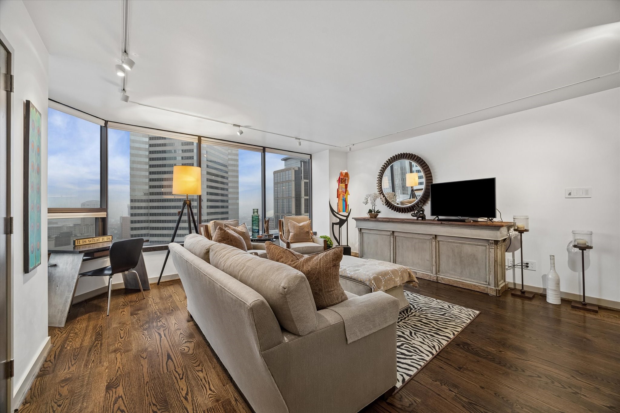 Windows on two sides give the corner living area multiple city outlooks. Open floor space connects the window wall with the kitchen and entry.