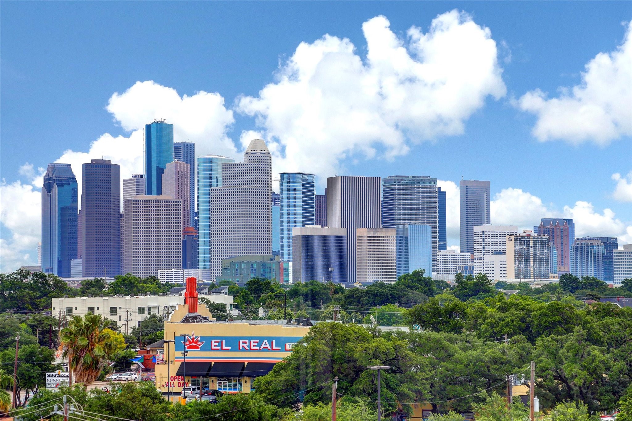 Houston skyline view provides broader city context for this downtown address. Towers and green spaces illustrate the surrounding urban landscape rather than a view from Unit 2601.