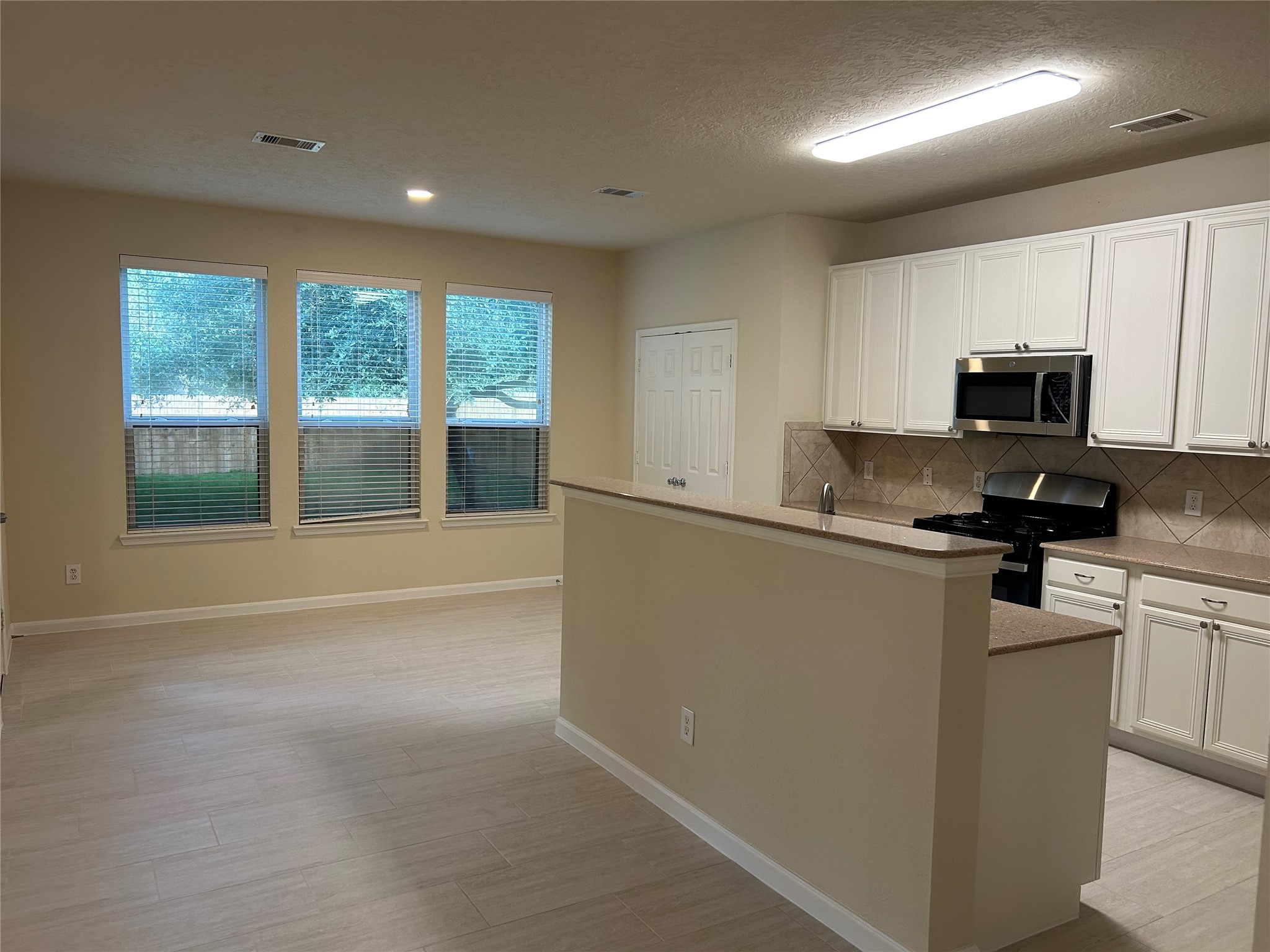 Entry to this gorgeous updated kitchen with breakfast bar, granite counters and newly installed appliances!