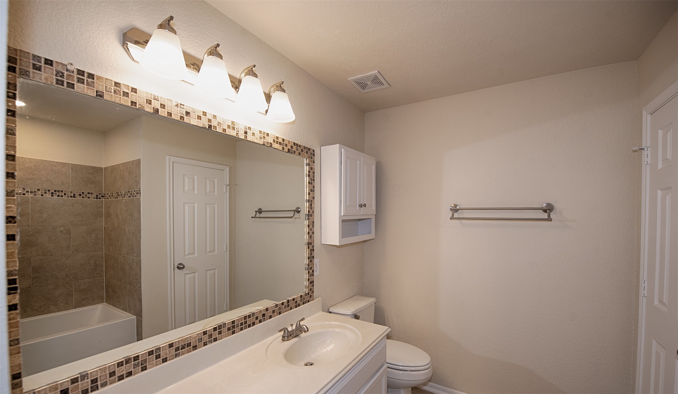 Master bath with updated mirror and extra long vanity.