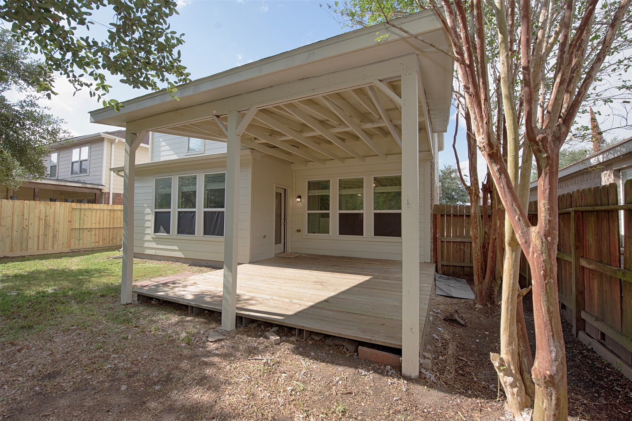 A closer look at the updated back deck from the yard. Side of the deck are gorgeous crepe myrtles. Certain to be gorgeous in the spring.