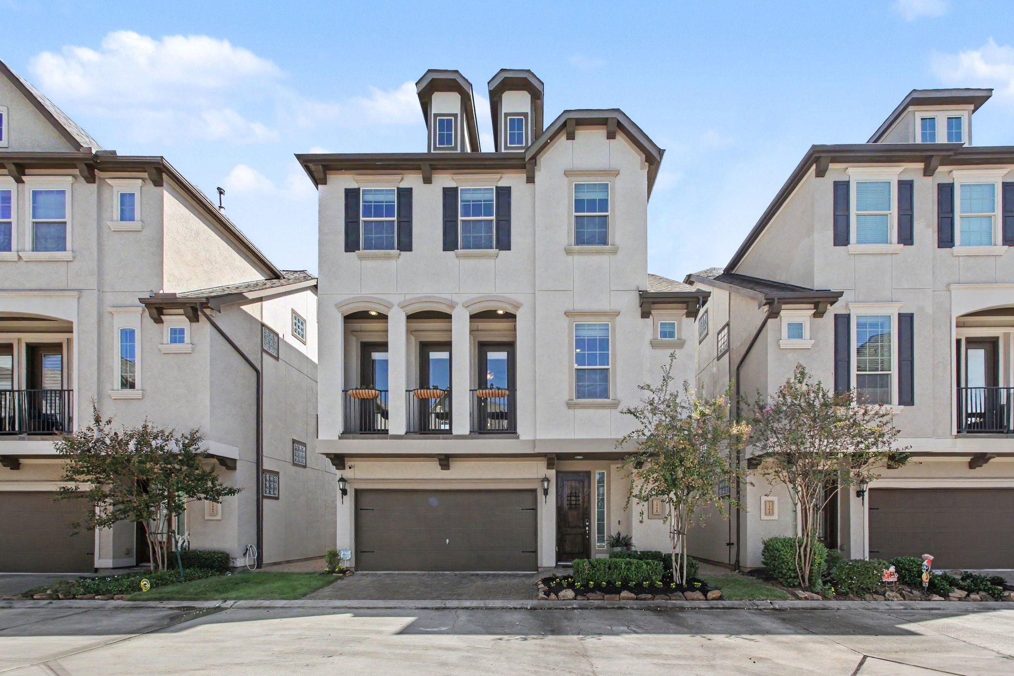 Elegant three-story home featuring a charming covered balcony, attractive architectural details Elegant three-story home featuring a charming covered balcony, attractive architectural details