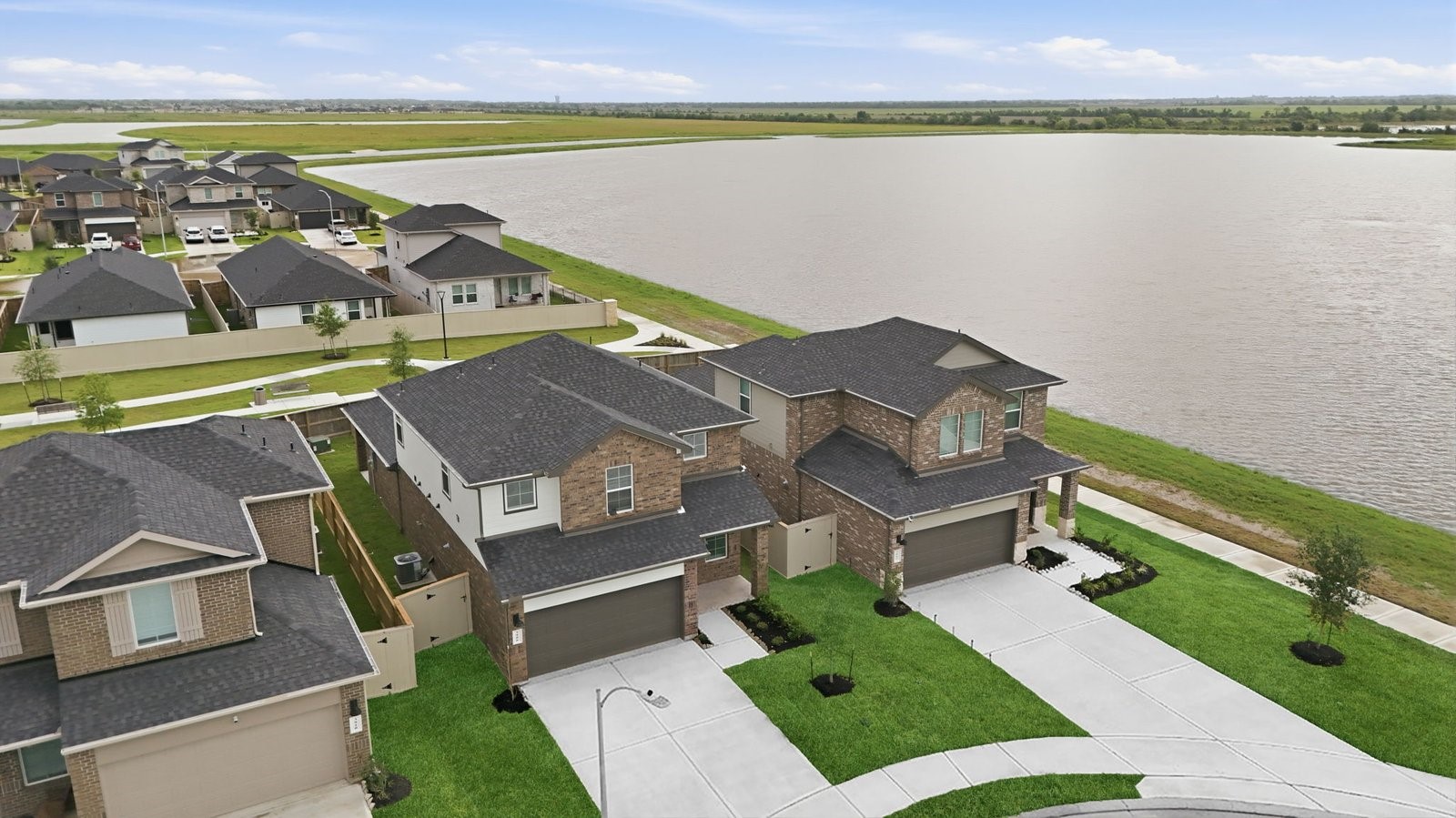 An aerial view of the newly built two story home with traditional architecture, a two car garage and a landscaped front yard An aerial view of the newly built two story home with traditional architecture, a two car garage and a landscaped front yard