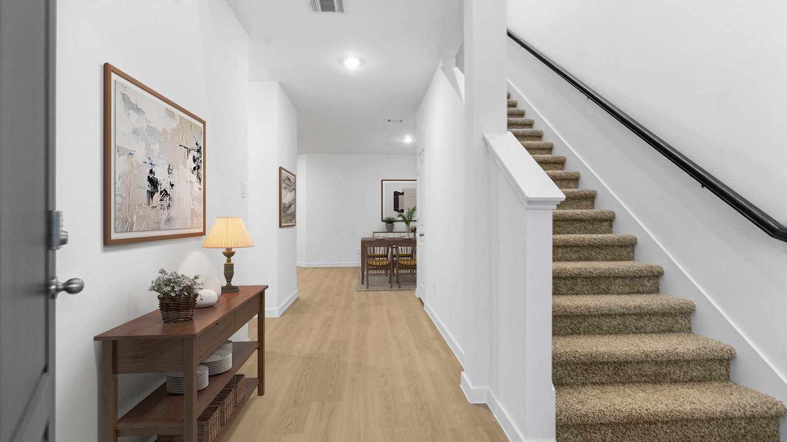 Entry hallway leading to living room and kitchen in the background. Entry hallway leading to living room and kitchen in the background.