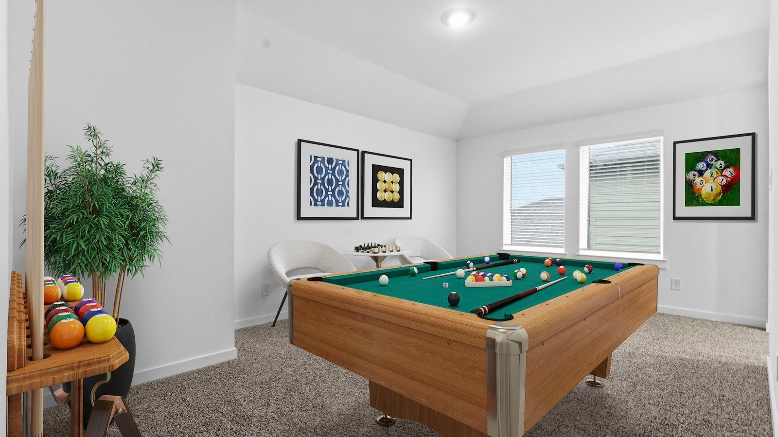 A spacious game room with plenty of natural light from windows overlooking side of the home