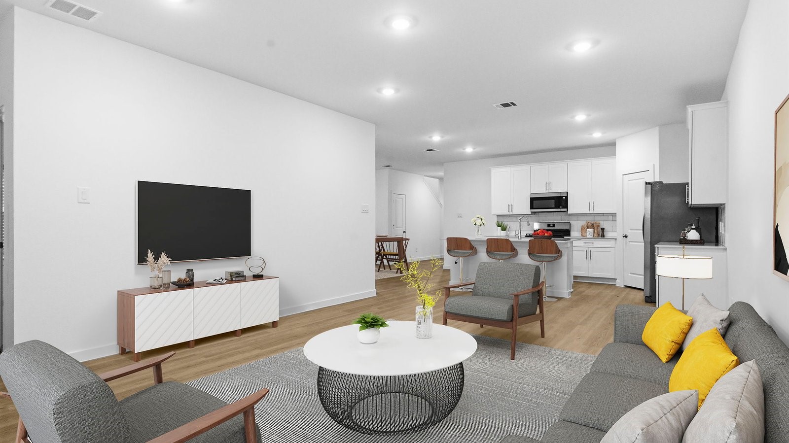 A well-organized living room that includes a kitchen and dining area, creating a warm and welcoming environment for gatherings. A well-organized living room that includes a kitchen and dining area, creating a warm and welcoming environment for gatherings.