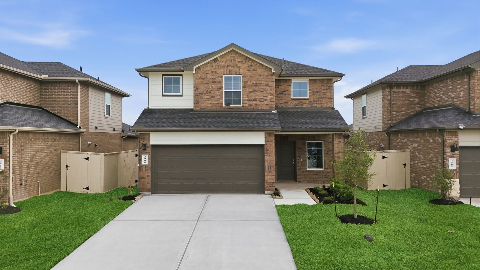 A two-story home with brick and stone exterior with a two-car garage and a well-maintained front lawn in league city A two-story home with brick and stone exterior with a two-car garage and a well-maintained front lawn in league city