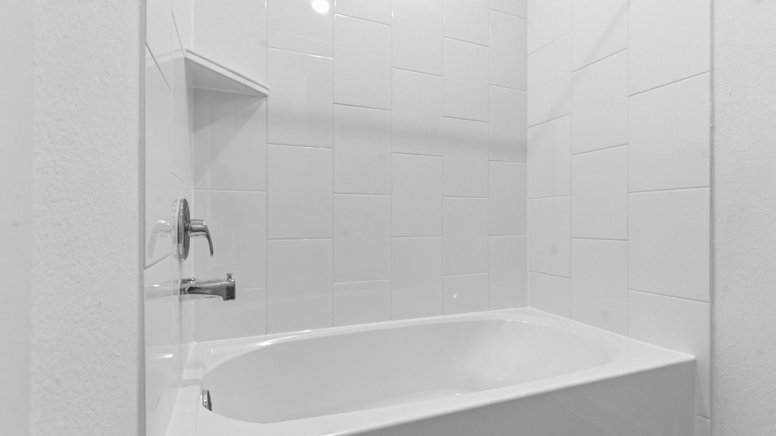 A well-designed bathroom equipped with quartz countertops, a standing tub, and a single vanity.