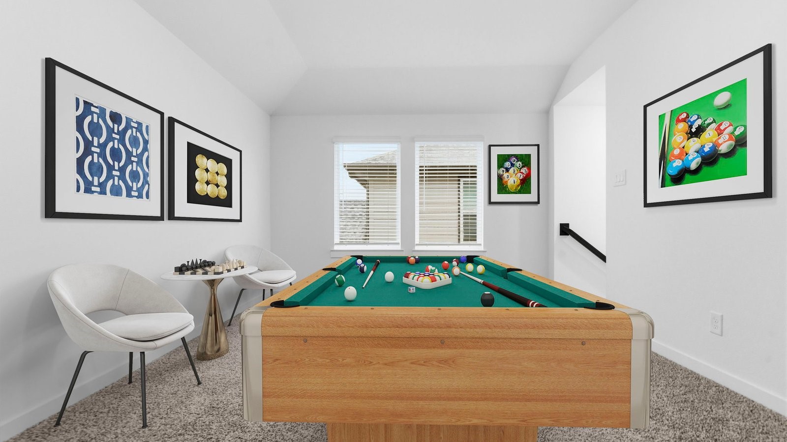 A spacious game room with plenty of natural light from windows overlooking side of the home