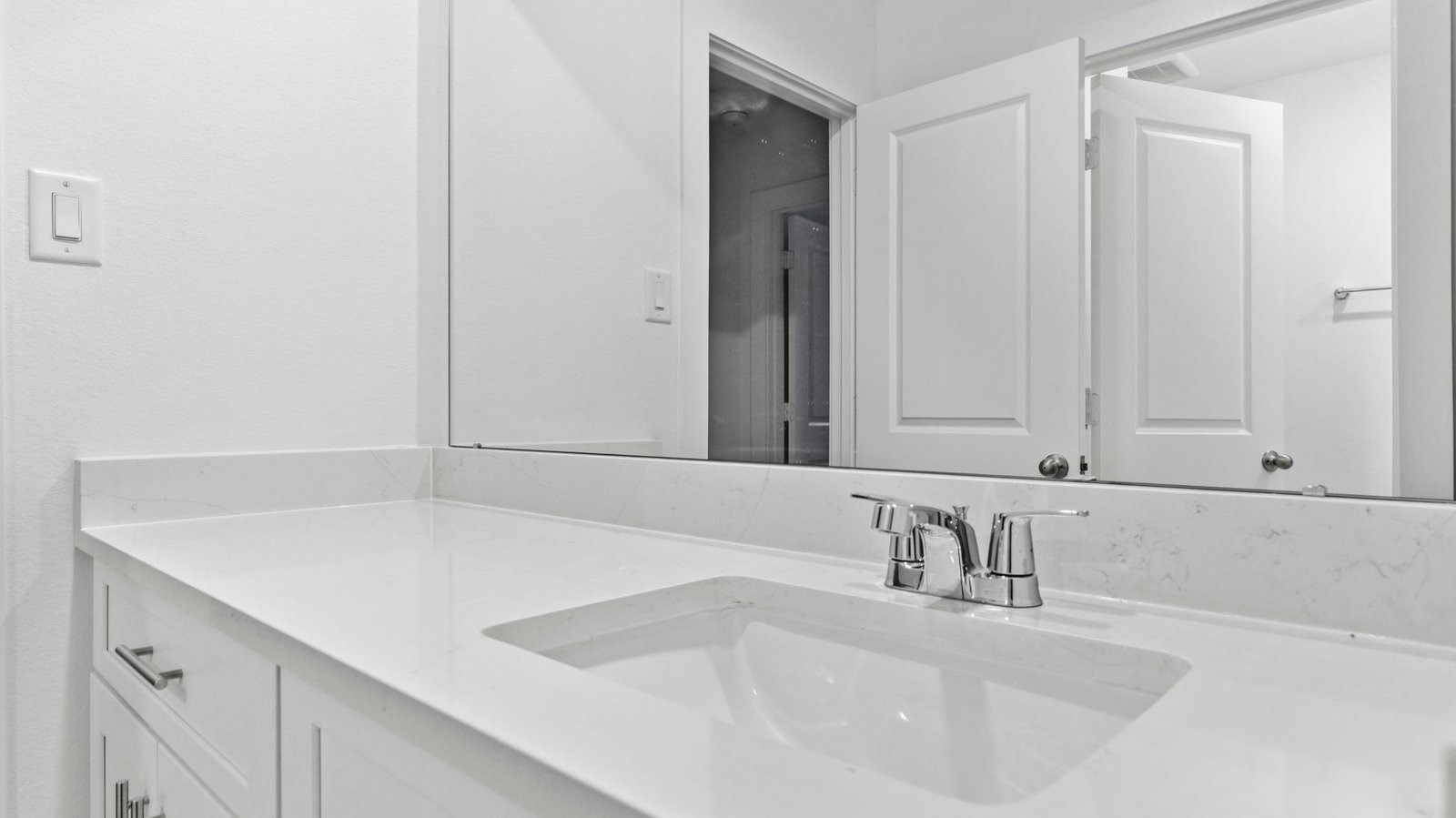 A well-designed bathroom equipped with quartz countertops, emphasizing functionality and contemporary style.